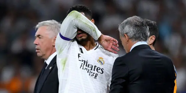 Jude Bellingham of Real Madrid briefly comes off of the pitch after picking up an injury