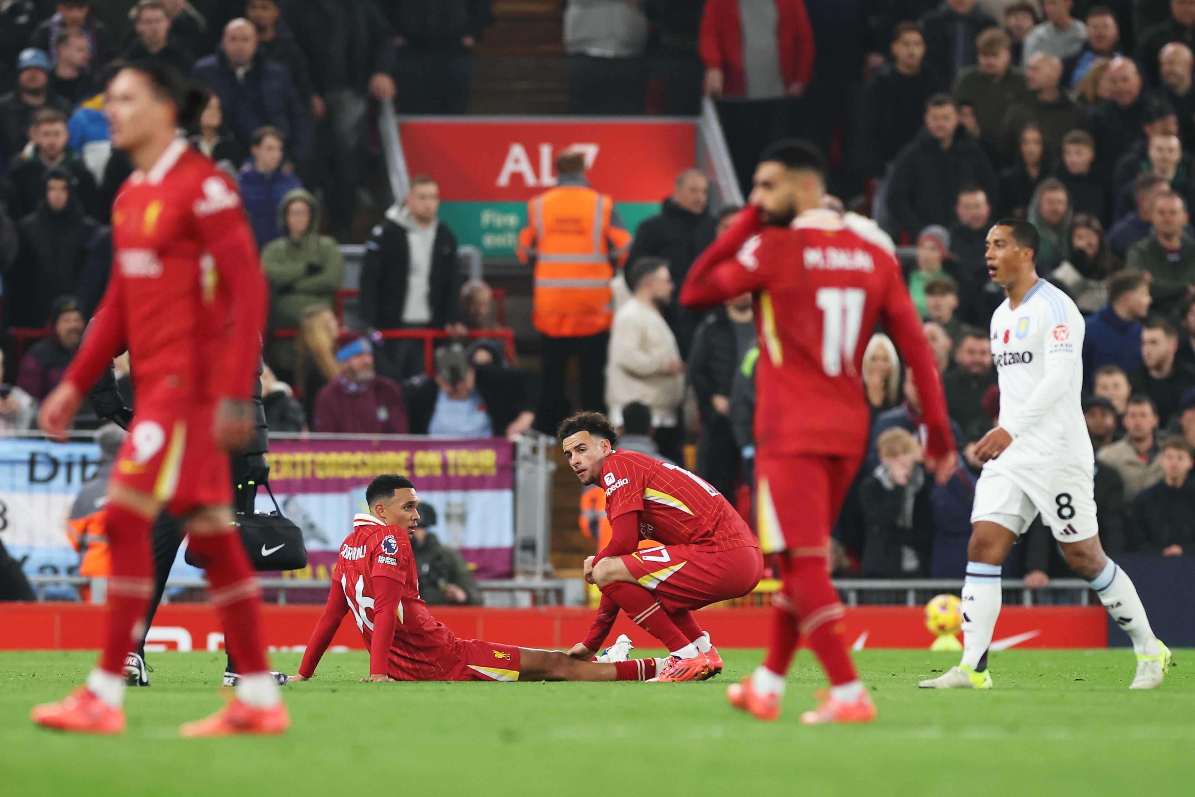 Trent Alexander-Arnold down with a hamstring injury during Aston Villa game.