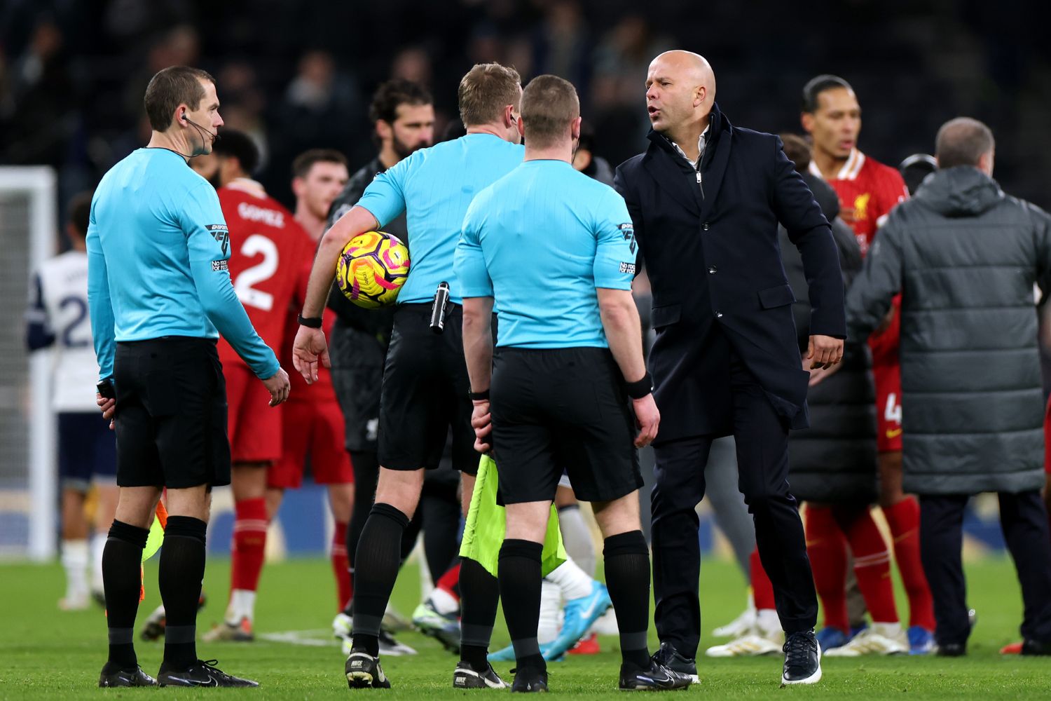 Arne Slot shakes hands with officials after beating Spurs