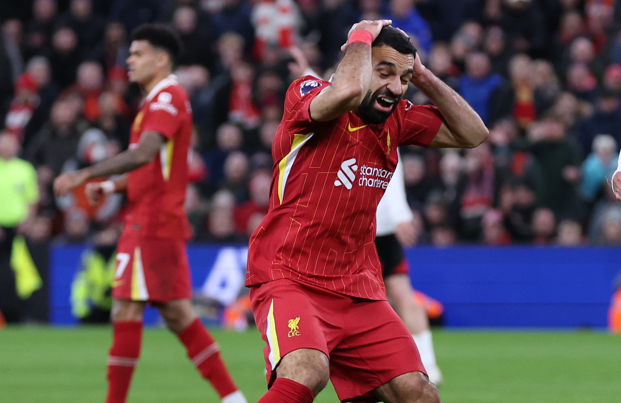 Mo Salah clutches his head in frustration as Luis Diaz walks in the background.