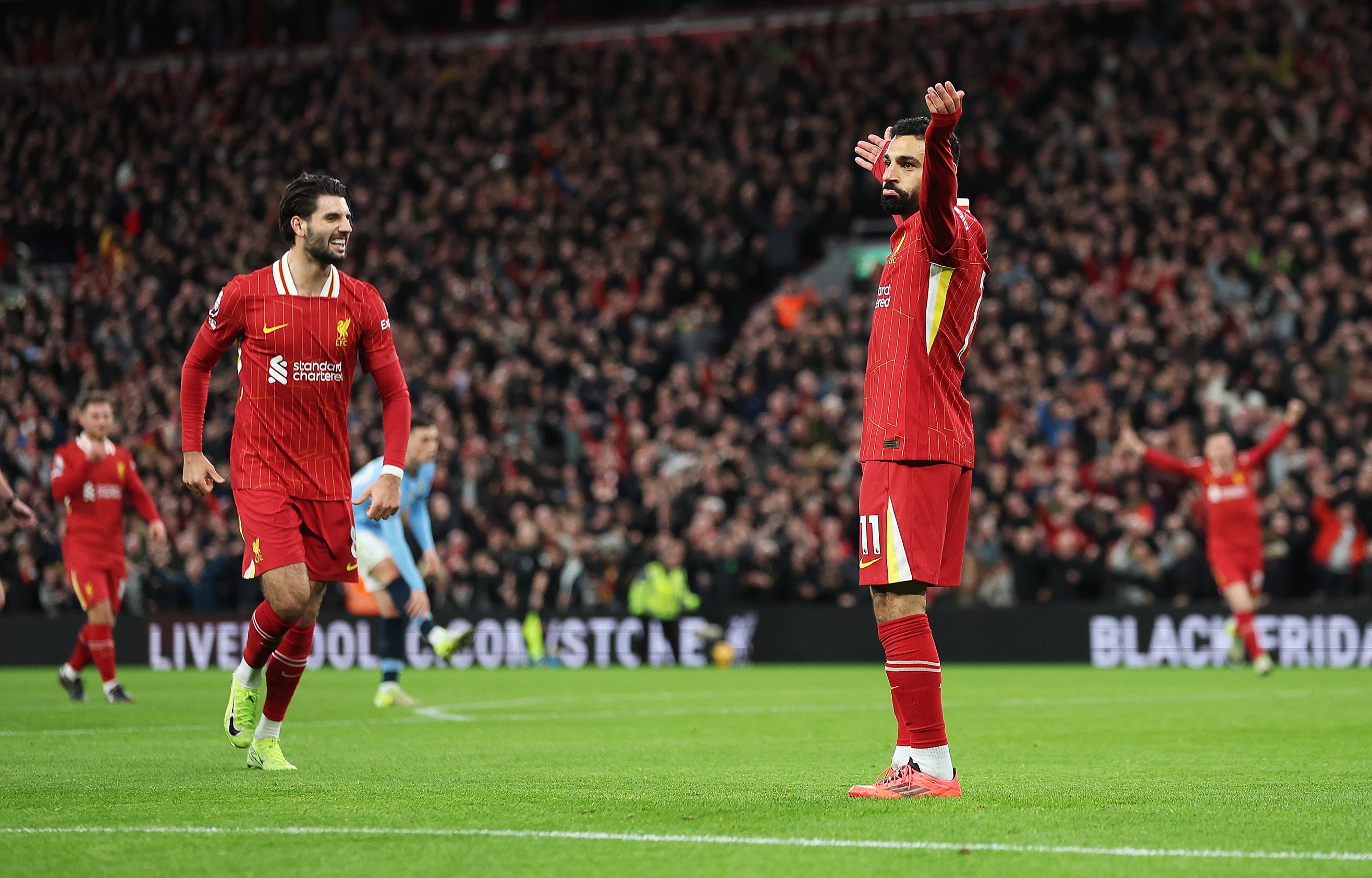 Mo Salah celebrates after providing an assist for Cody Gakpo.