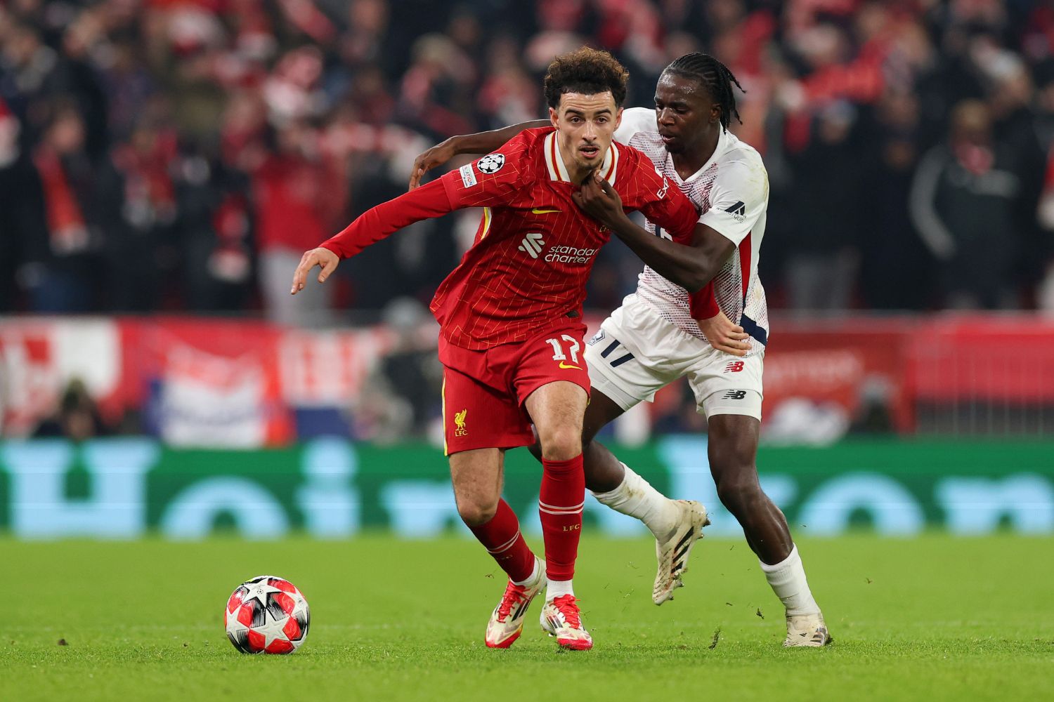 Curtis Jones competes for the ball against Lille