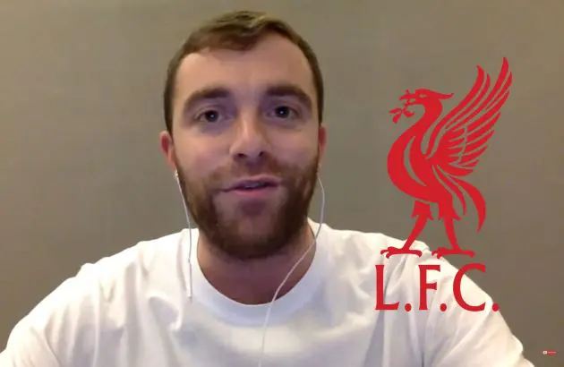 Fabrizio Romano smiles next to Liverpool club crest.