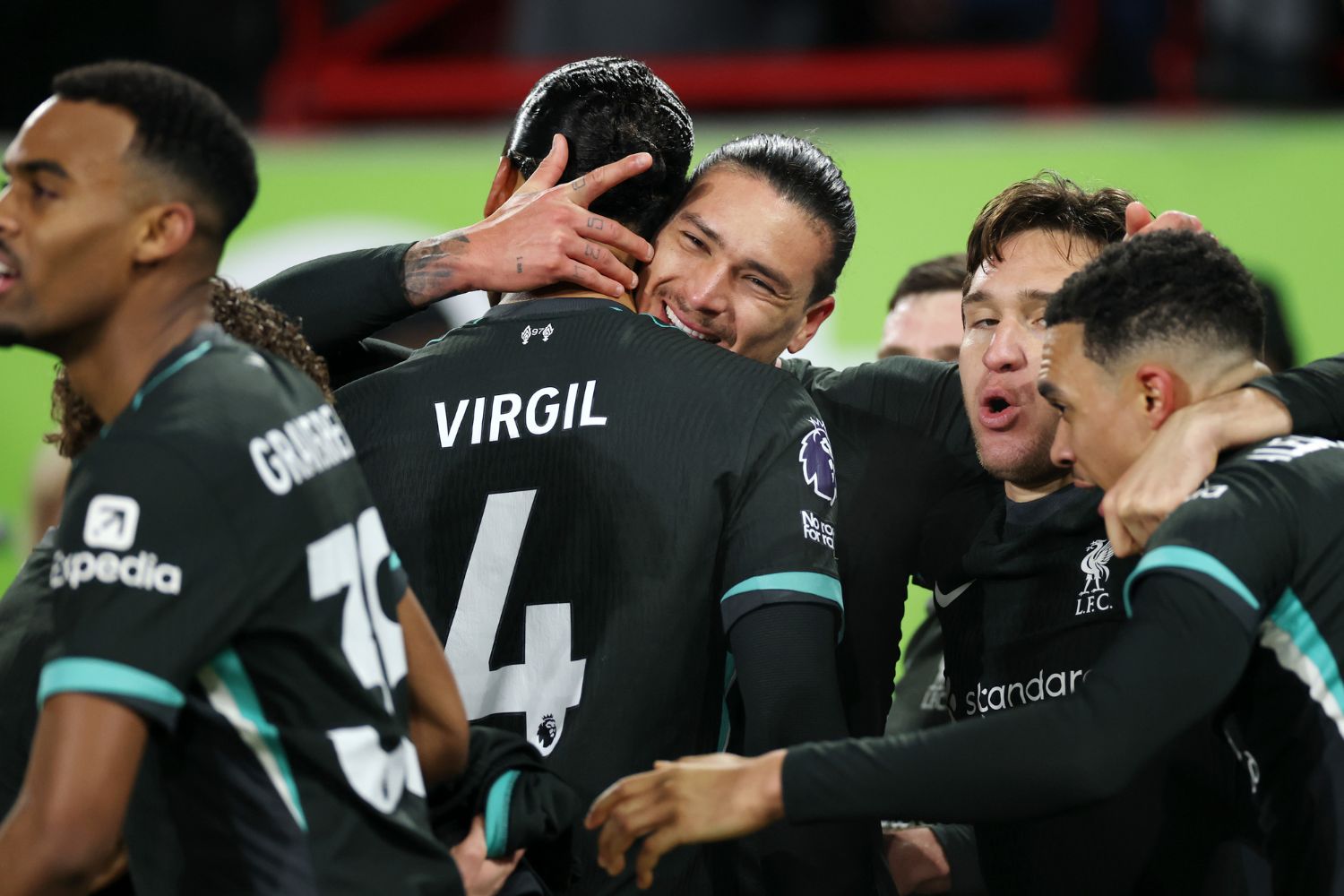 Virgil van Dijk surrounded by teammates at Brentford