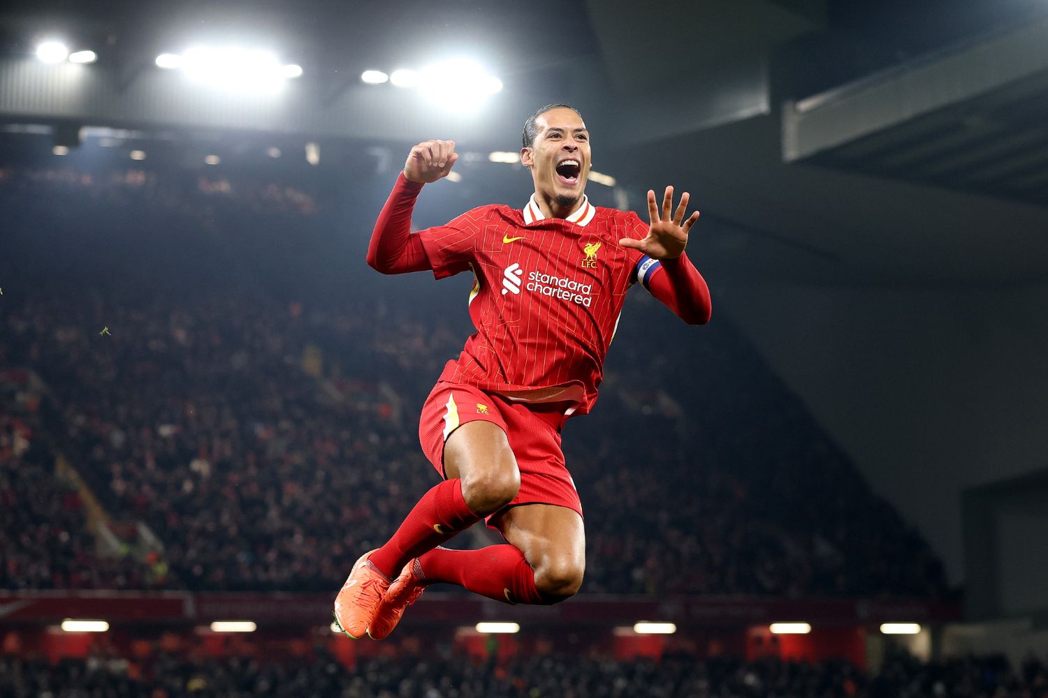 Virgil van Dijk celebrates in front of the Kop
