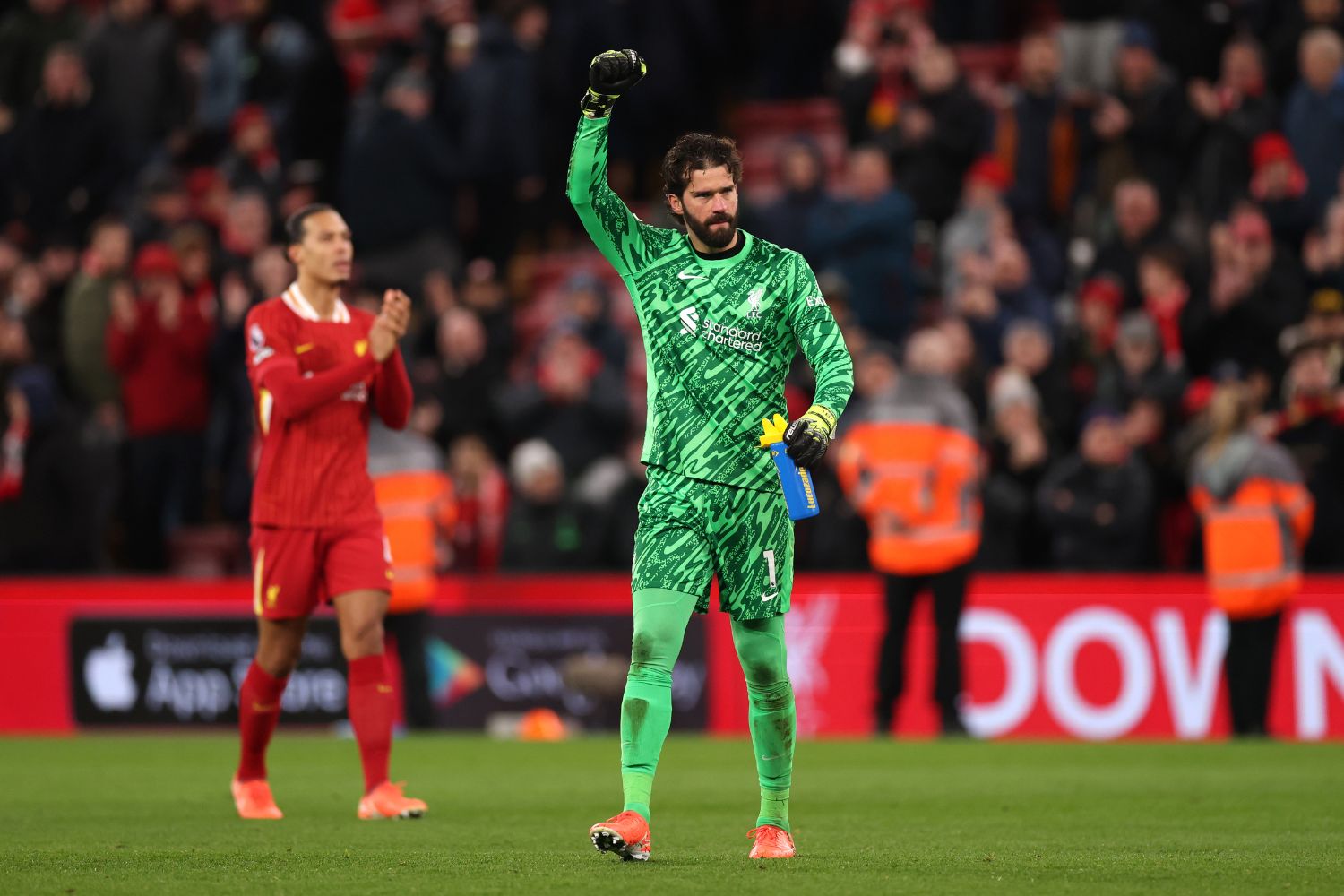 Alisson celebrates in front of Liverpool fans