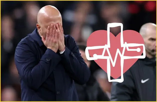 Arne Slot covers his face with his hands.