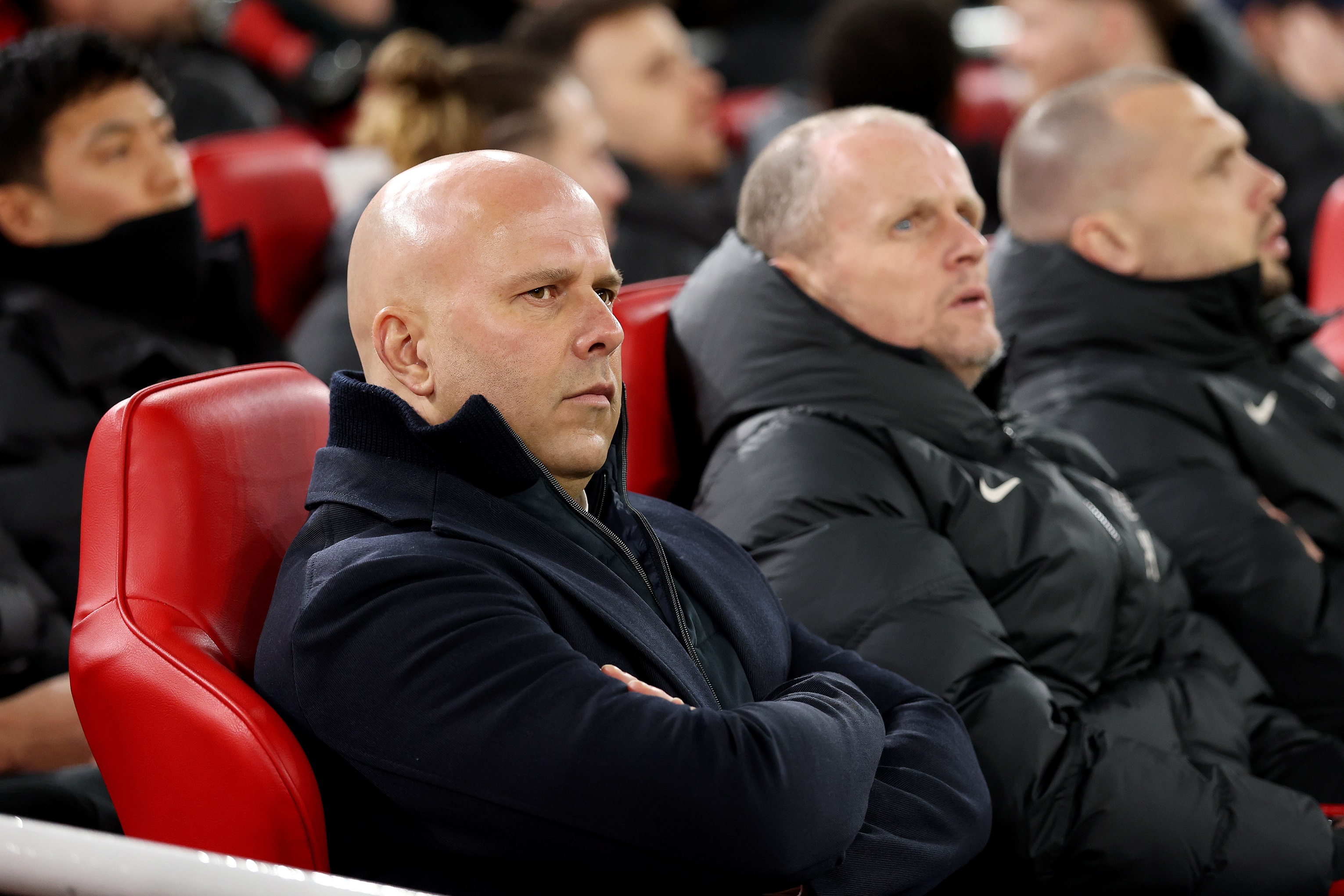 Arne Slot sits on the Liverpool bench next to Sipke Hulshoff.