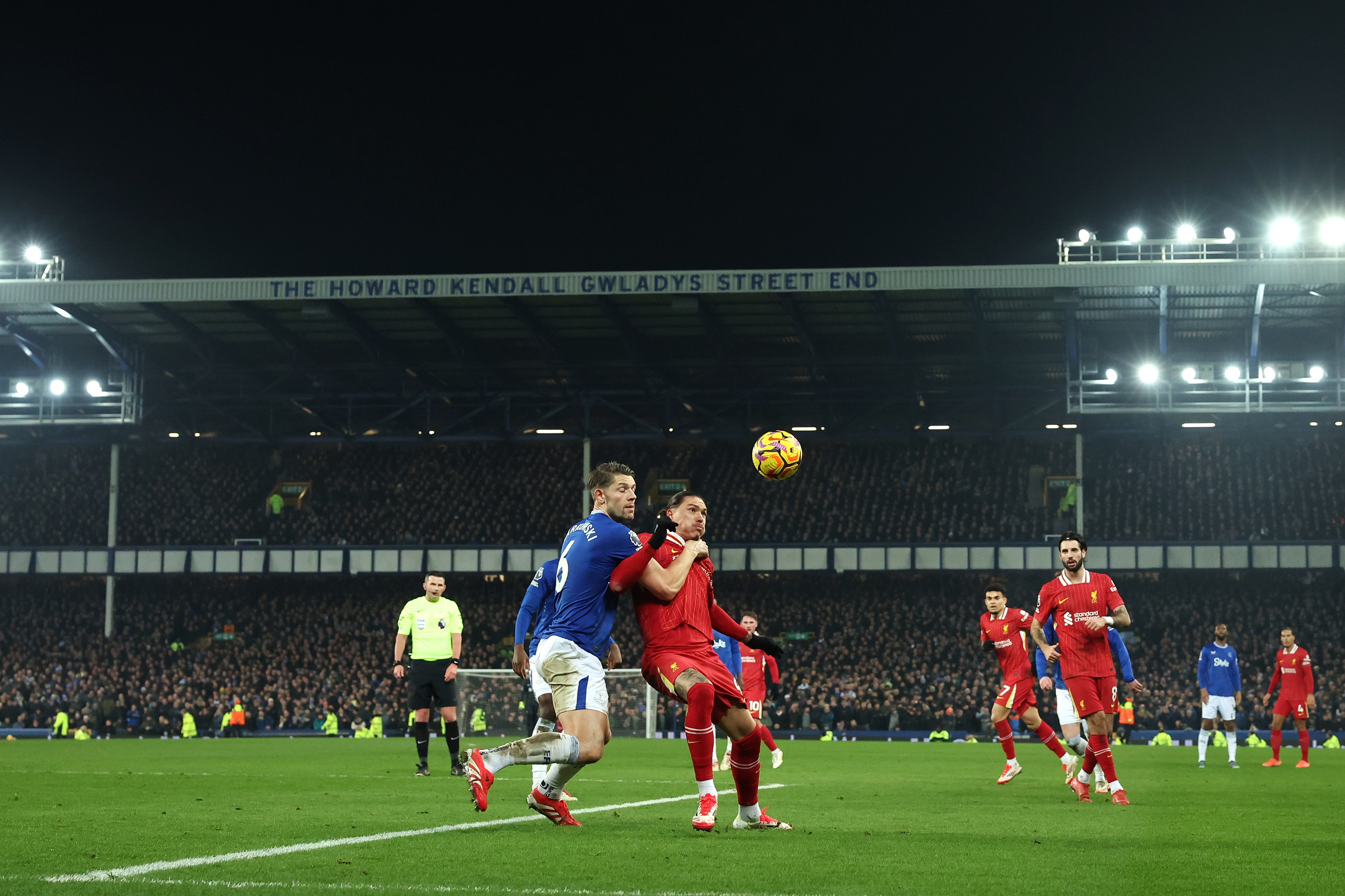 Darwin Nunez holds off James Tarkowski as he receives the ball.