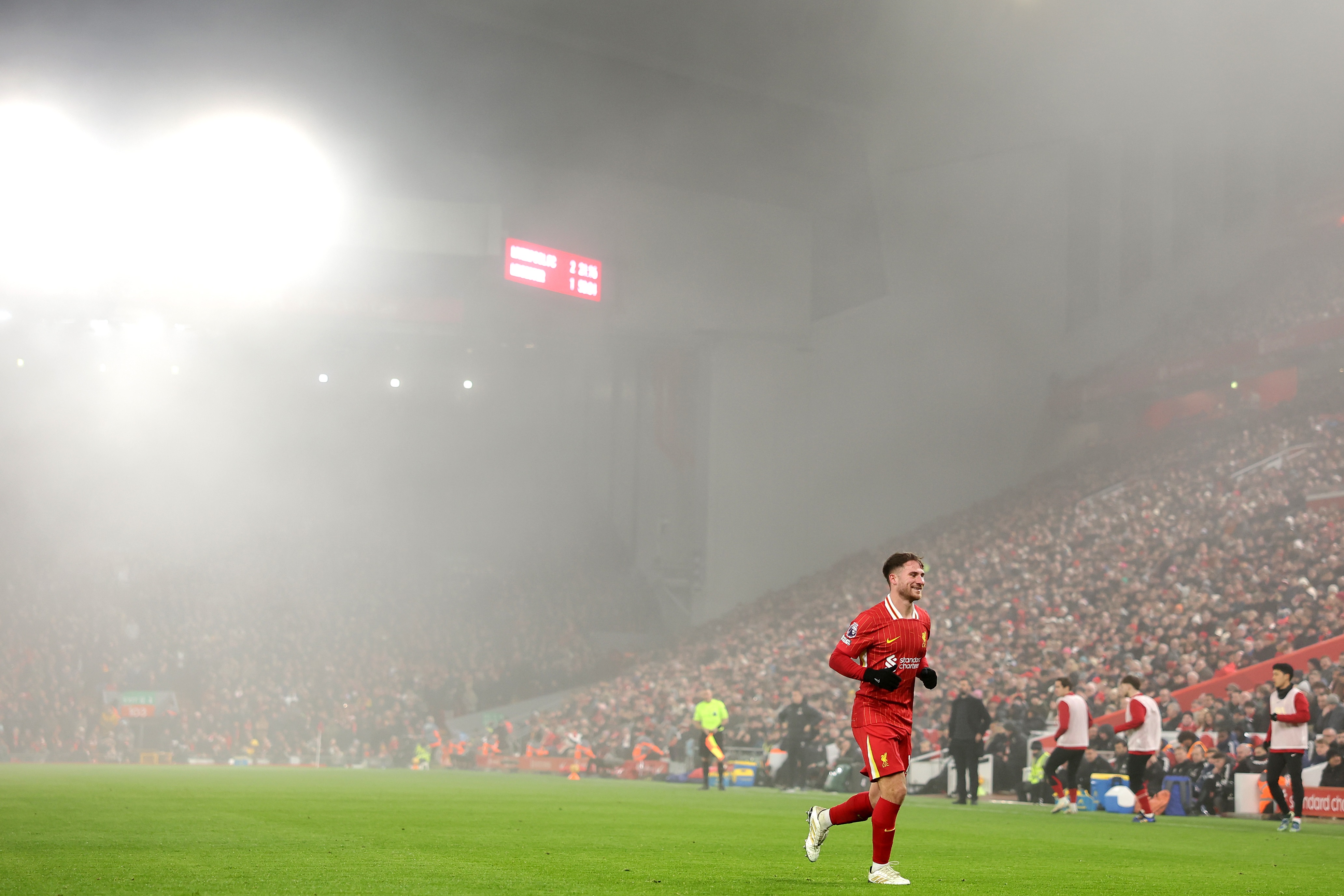 Alexis Mac Allister jogs on the pitch at Anfield.