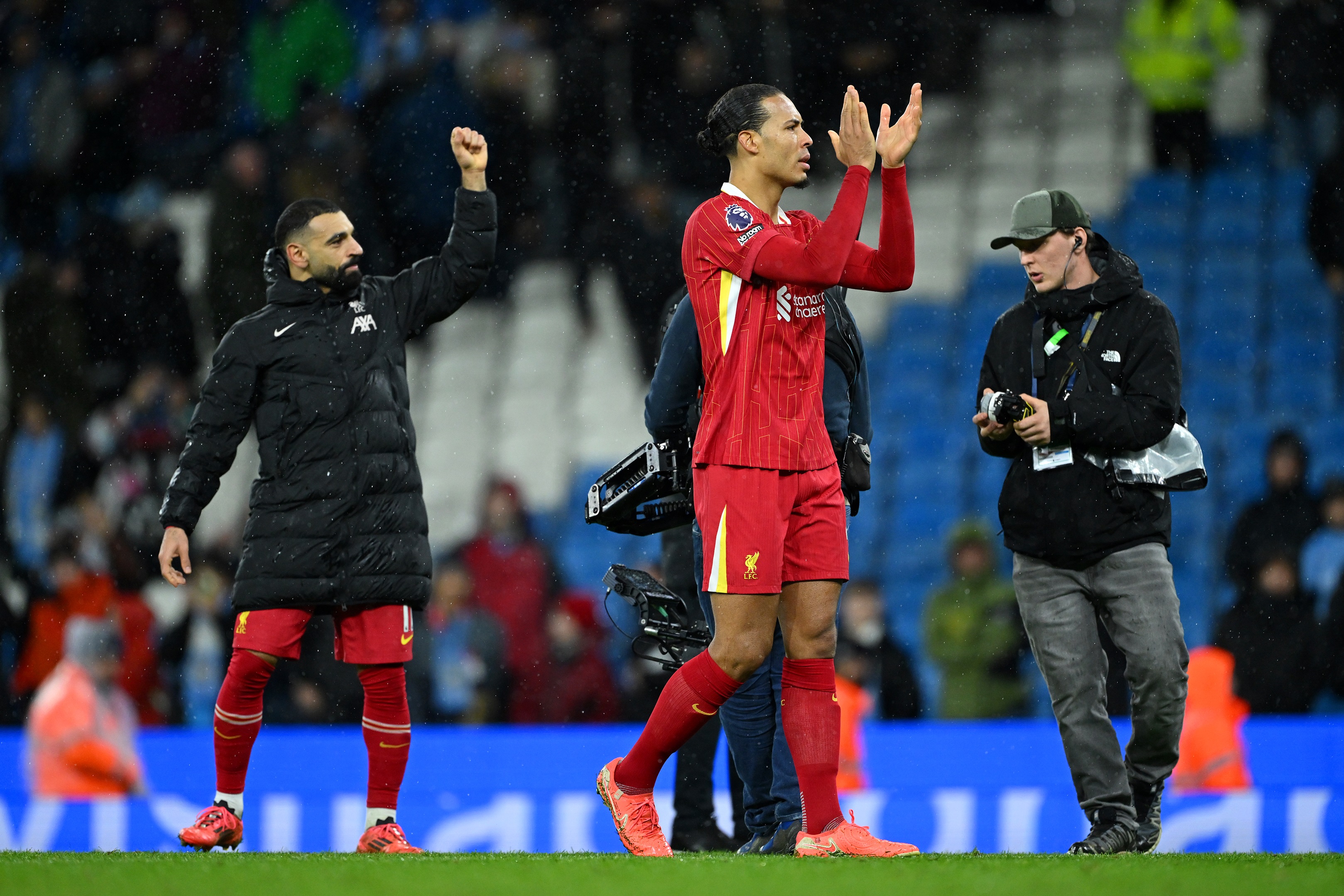 Mo Salah and Virgil van Dijk clap Liverpool's travelling fans at the Etihad.