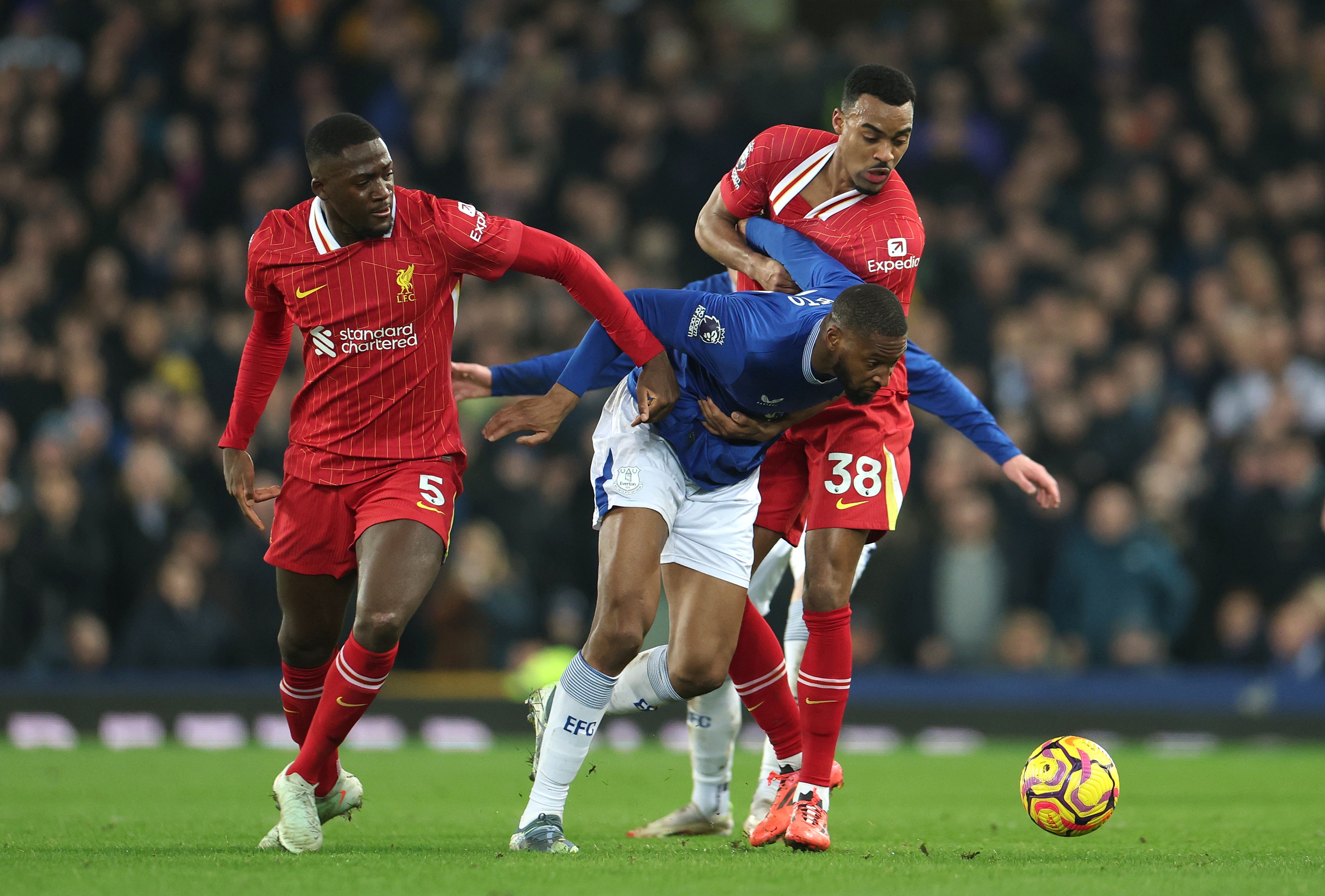 Ibrahima Konate grabs Everton's Beto at Goodison Park.