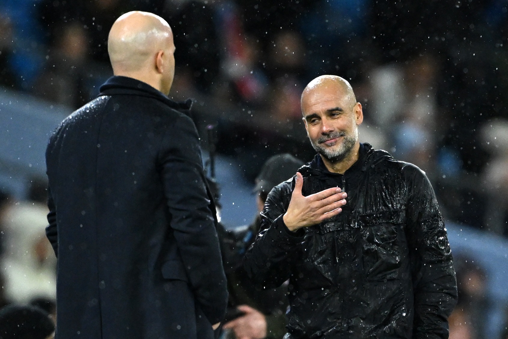 Pep Guardiola shakes Liverpool head coach Arne Slot's hand.