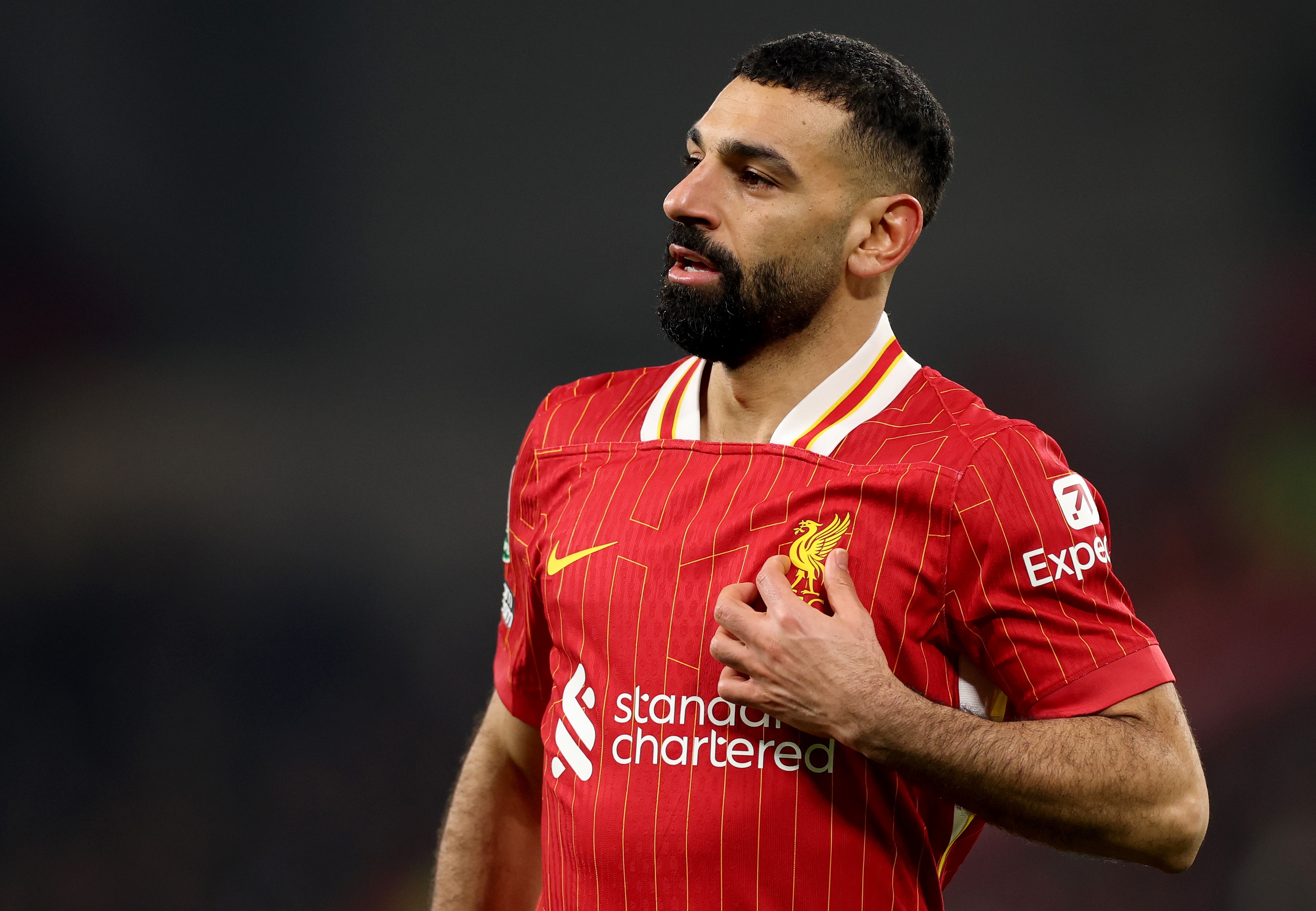 Mo Salah clutches Liverpool crest on his chest at Anfield.
