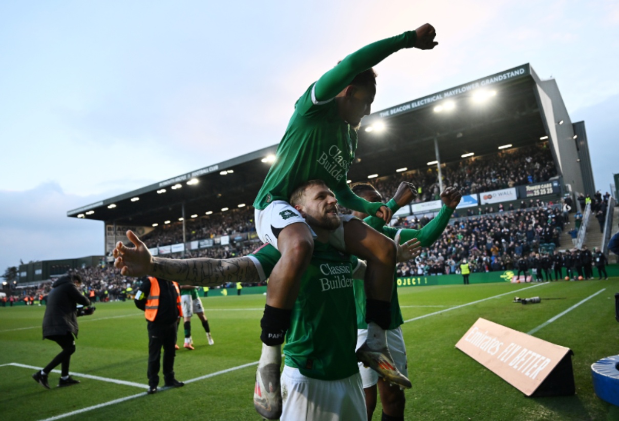 Plymouth Argyle players celebrate beating Liverpool in the FA Cup