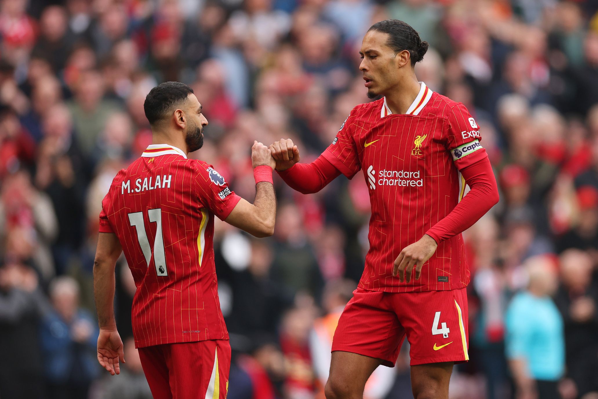 Virgil van Dijk and Mo Salah celebrate a goal at Anfield