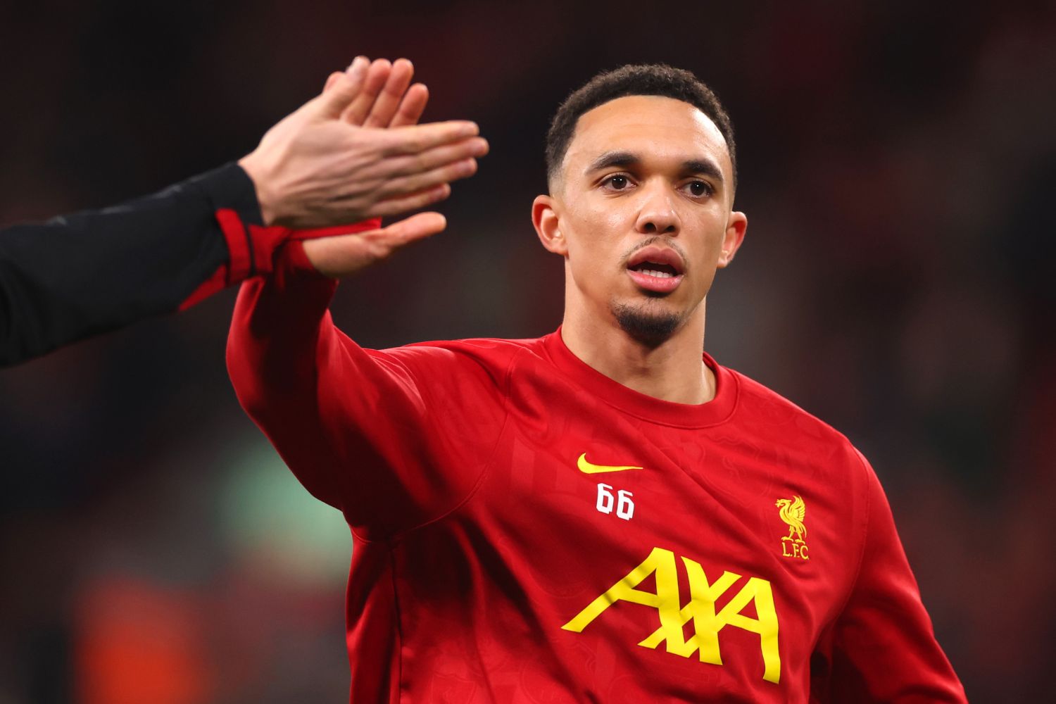 Trent Alexander-Arnold warms up for Liverpool at Anfield