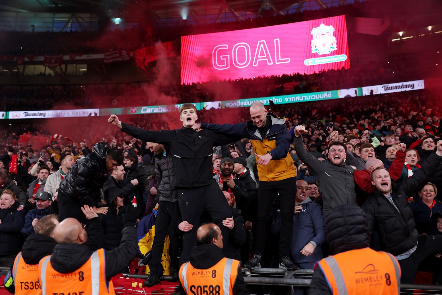 Liverpool fans celebrate scoring at Wembley
