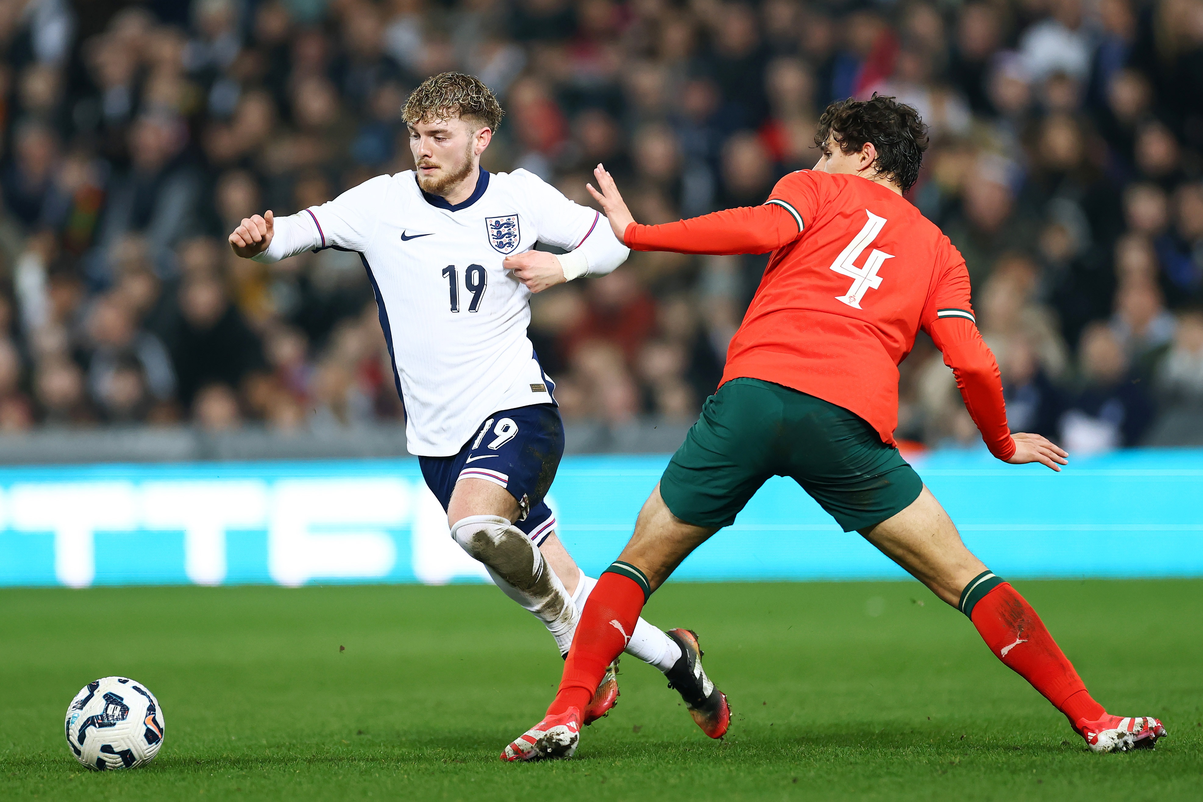 Harvey Elliott dribbles away from an outstretched leg.