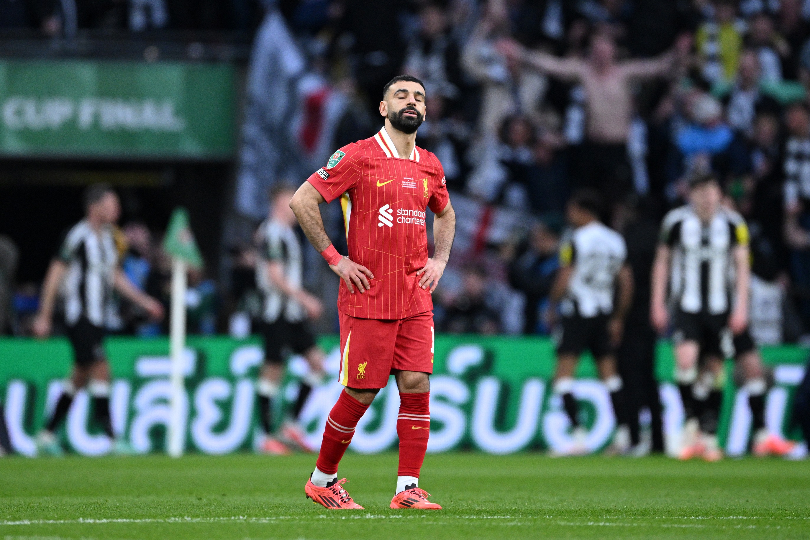 Mo Salah looks disappointed with his hands on his hips.