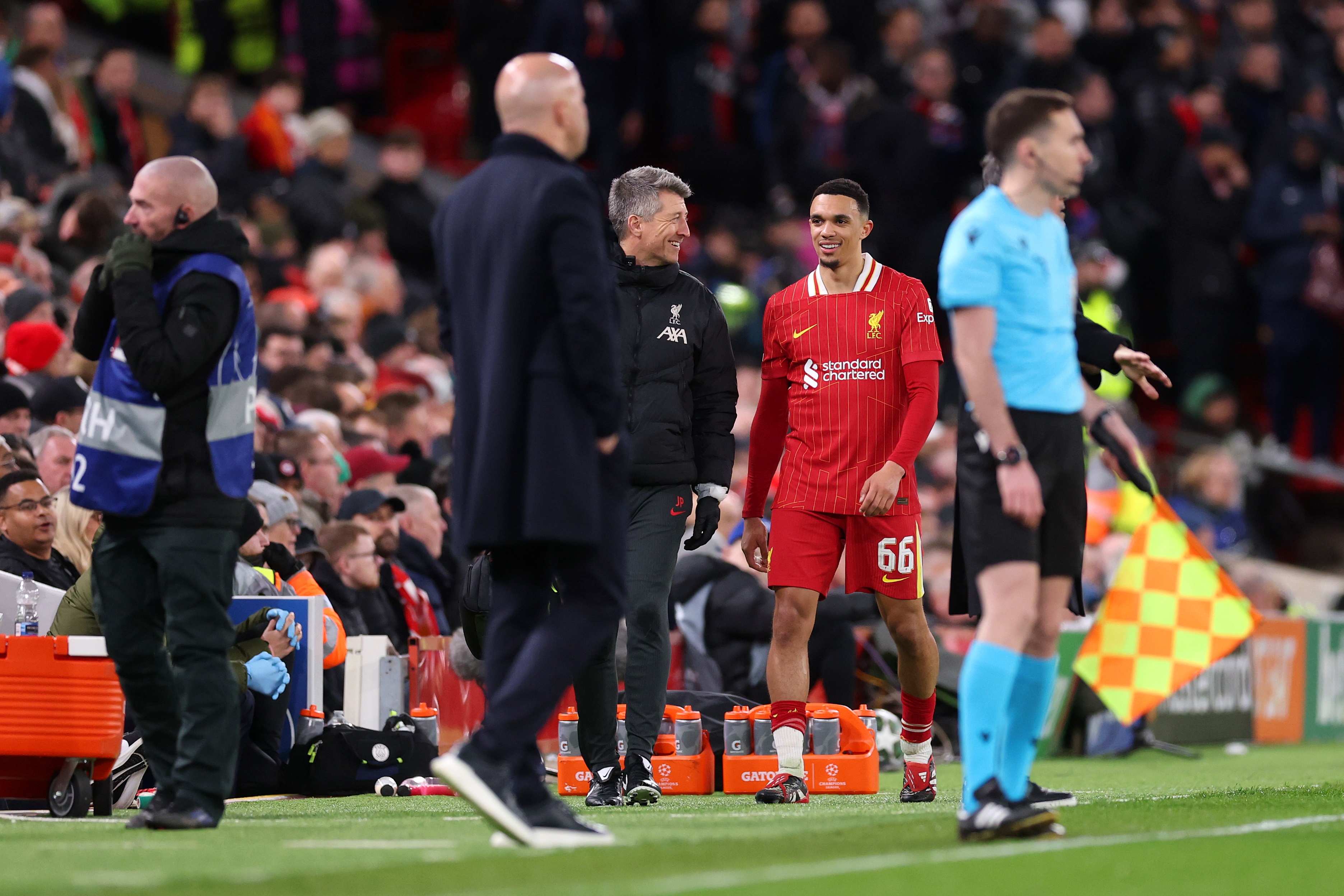 Trent Alexander-Arnold walks on the touchline to Arne Slot.