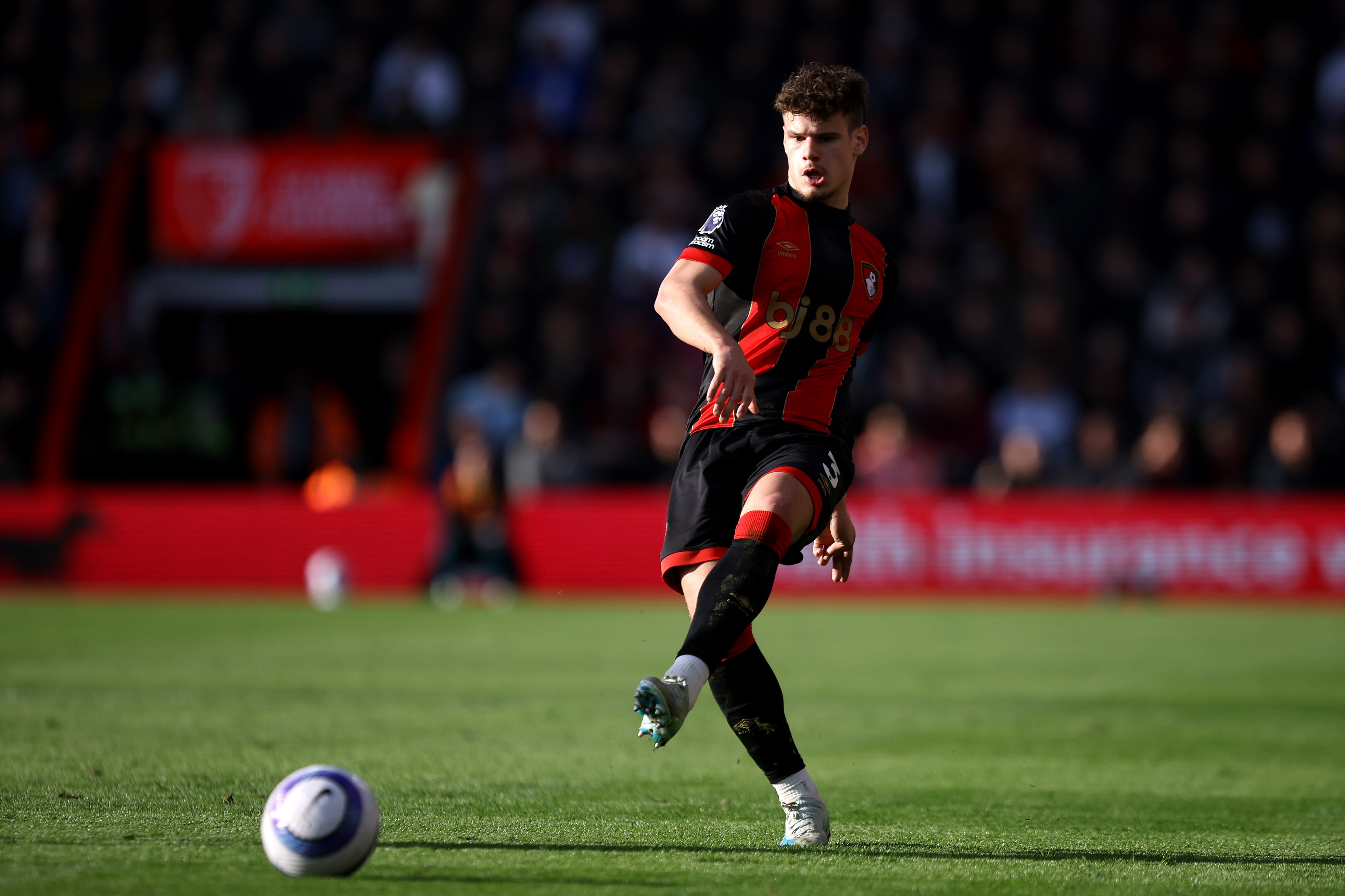 Milos Kerkez plays a pass for Bournemouth.