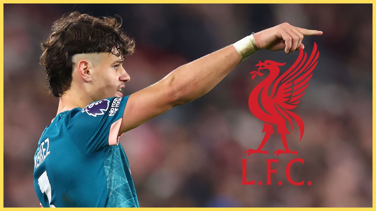 Milos Kerkez points at Liverpool club crest.