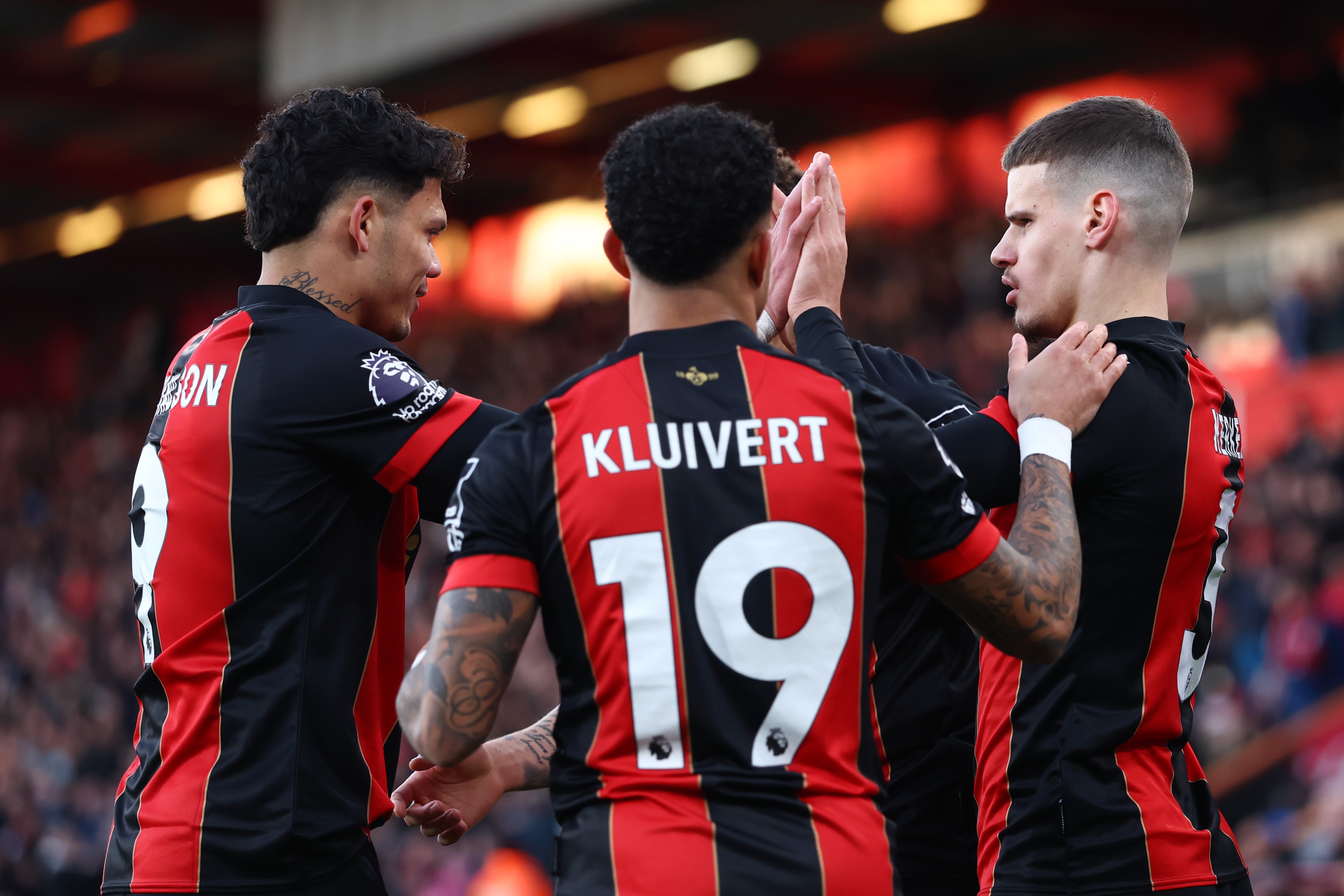 Milos Kerkez high-fives Bournemouth teammates.