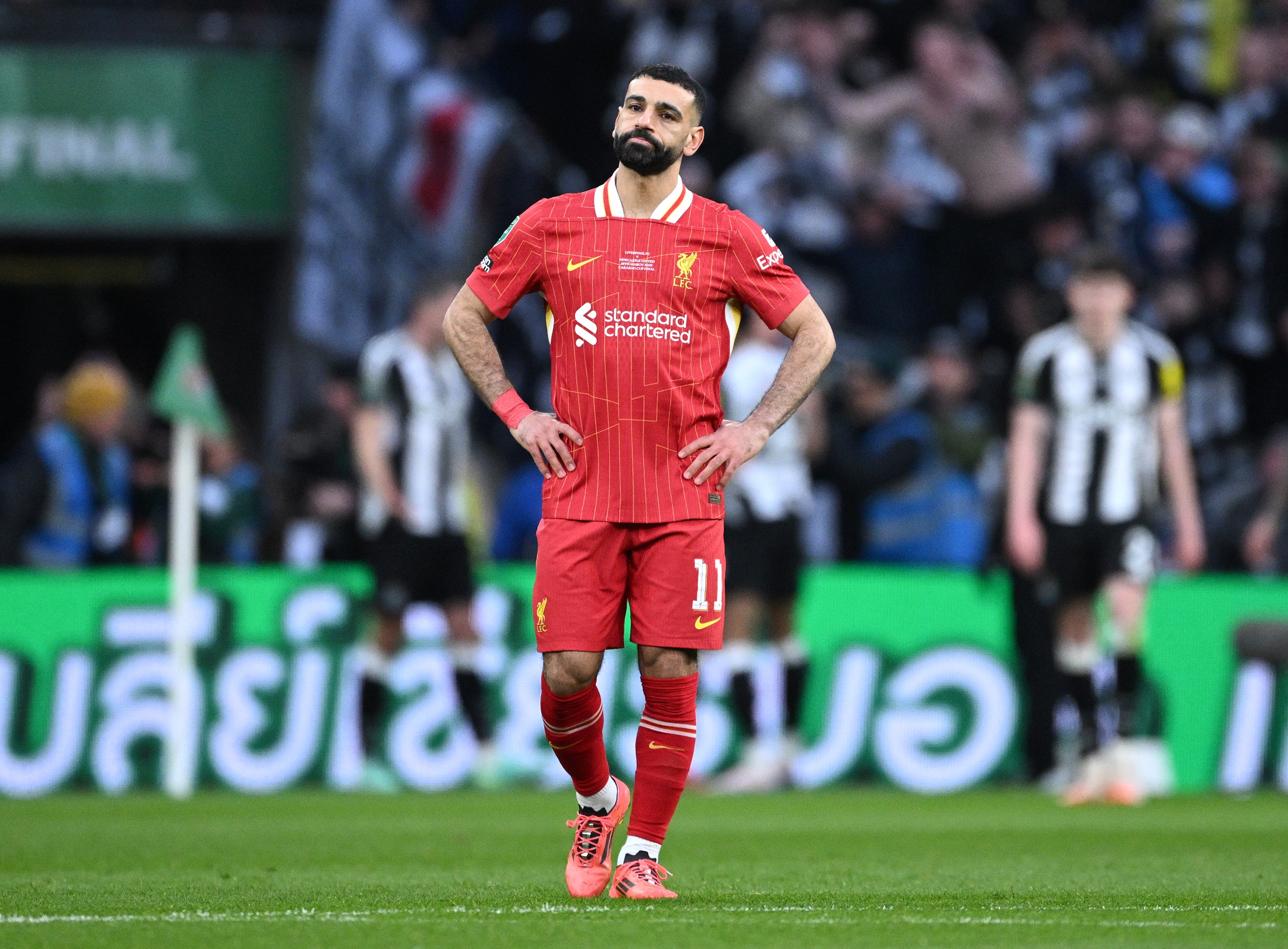 Mo Salah looks disappointed with his hands on his hips.