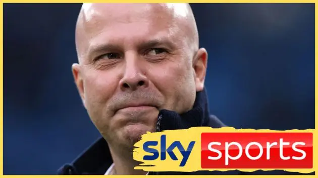 Liverpool head coach Arne Slot smiles wryly behind Sky Sports logo.