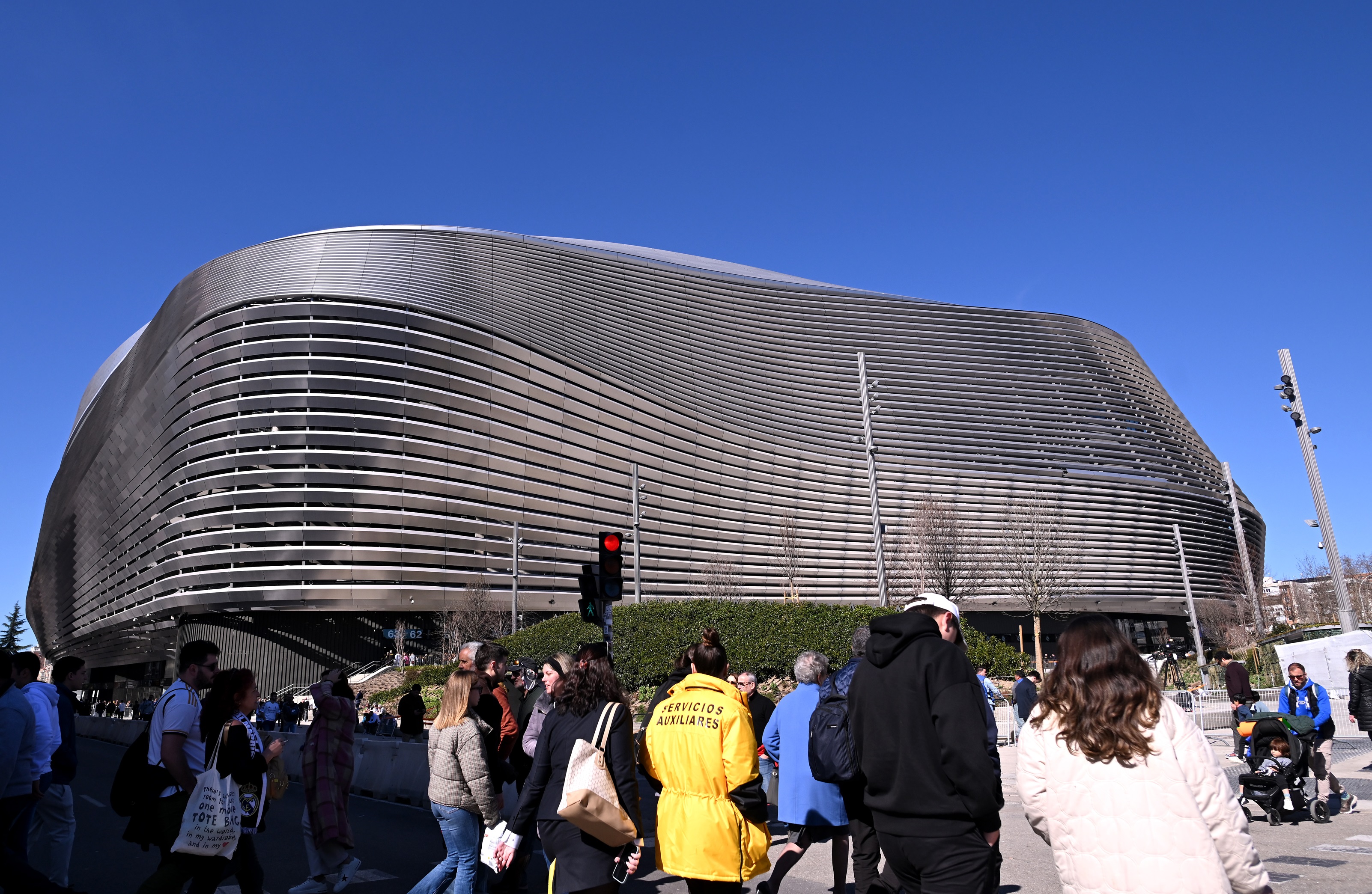Pedestrians walks by Real Madrid's Santiago Bernabeu stadium.