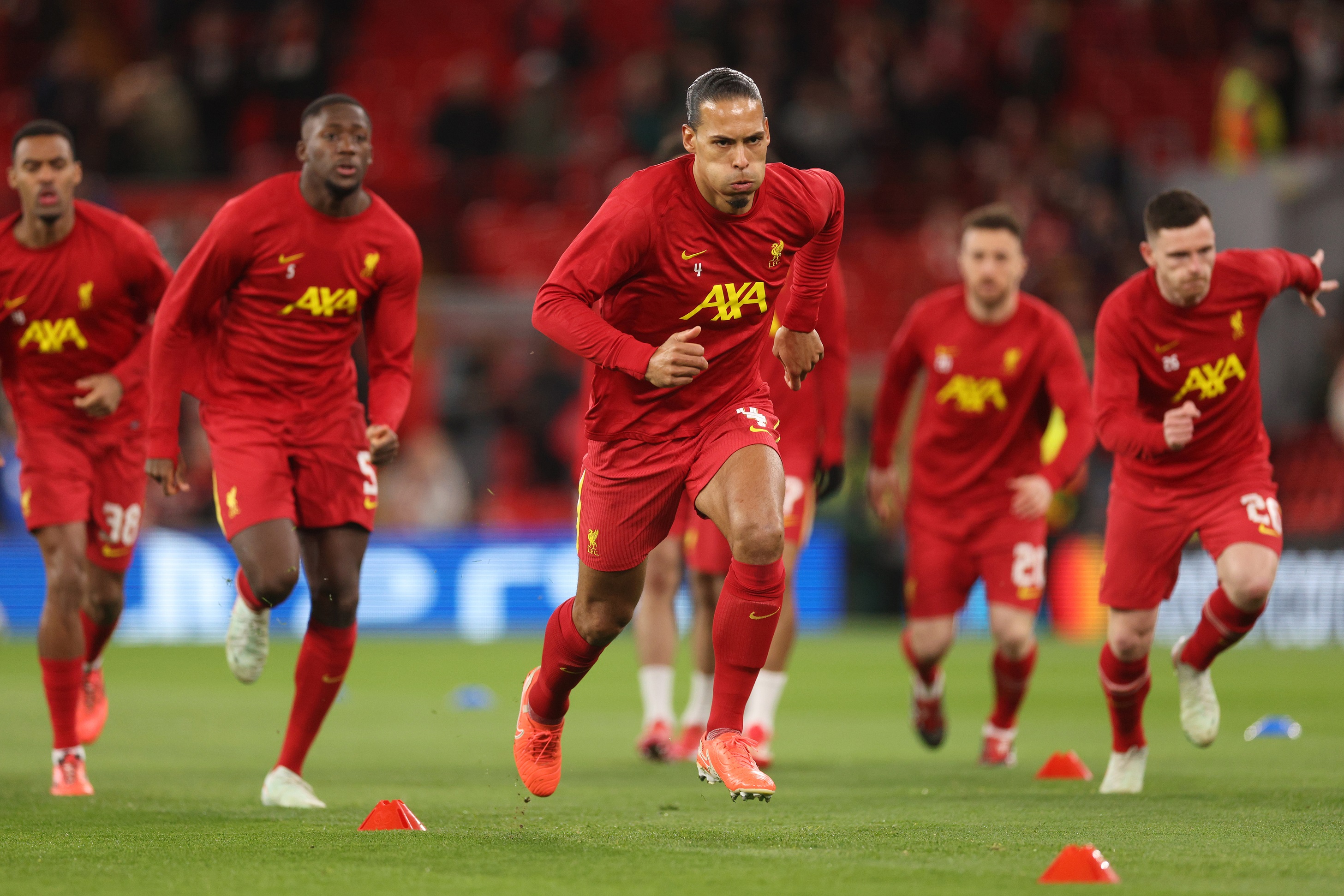 Virgil van Dijk warms up ahead of PSG clash.