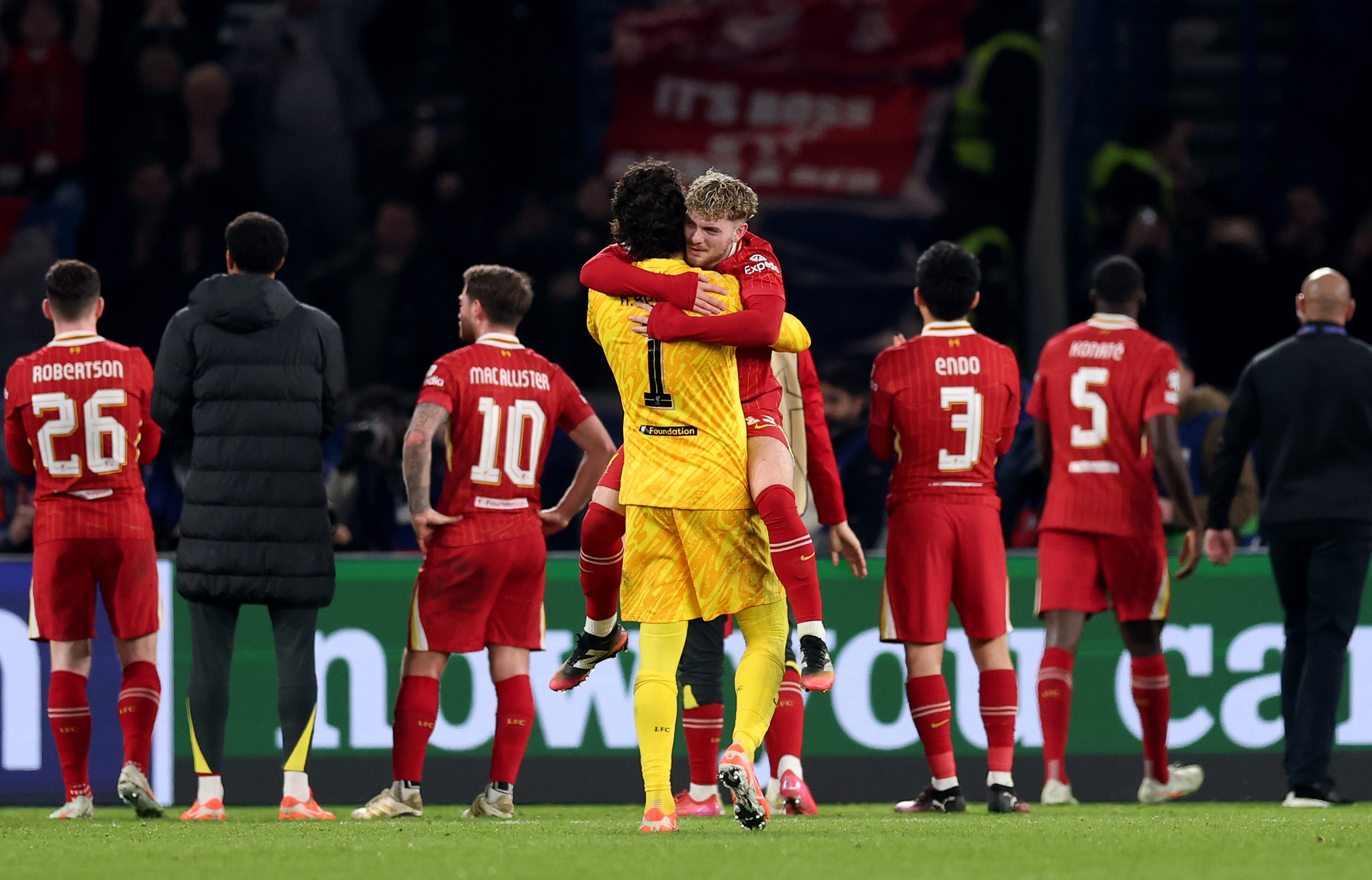 Alisson Becker and Harvey Elliott celebrate after Liverpool's win away to PSG