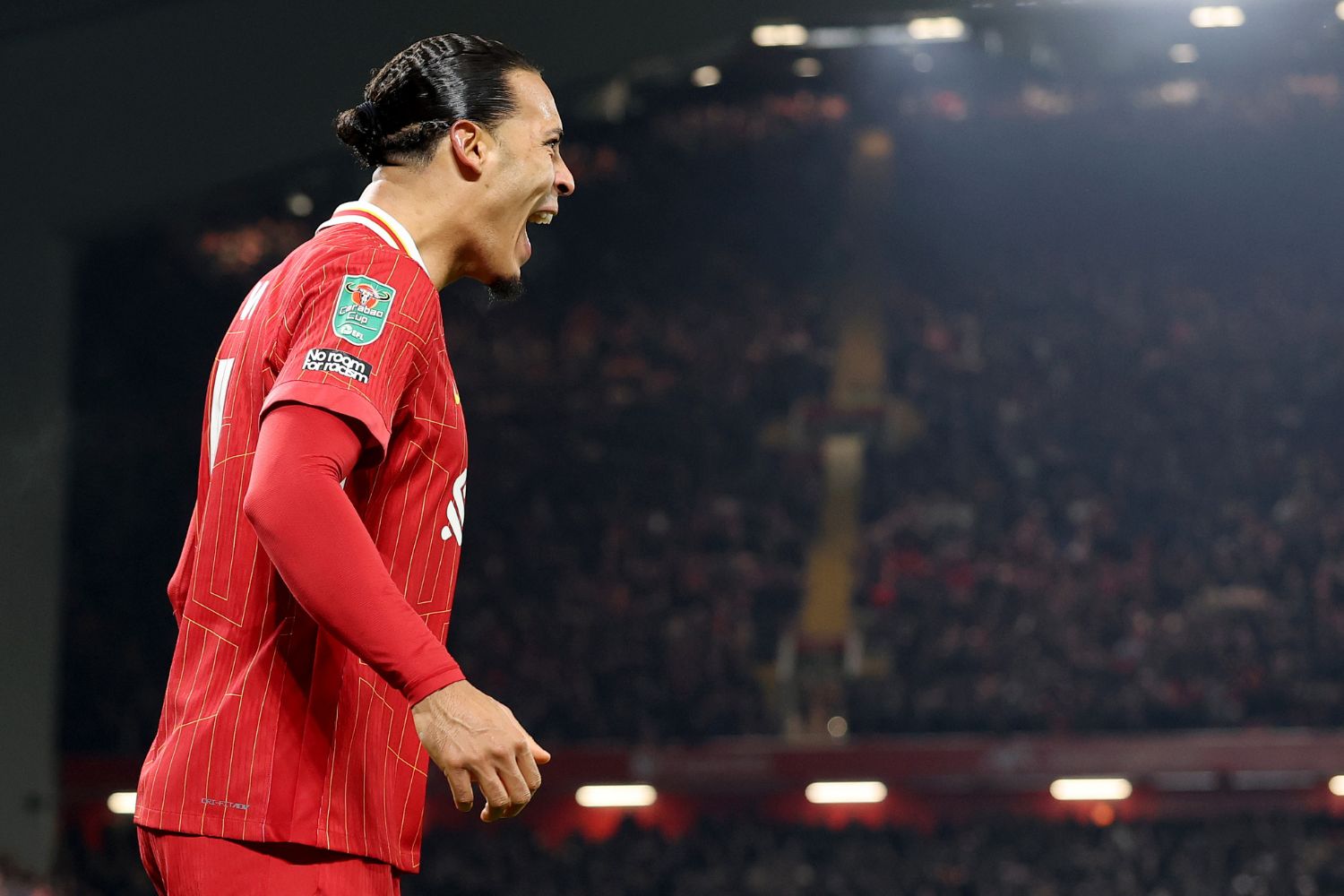 Virgil van Dijk celebrates in front of Liverpool fans
