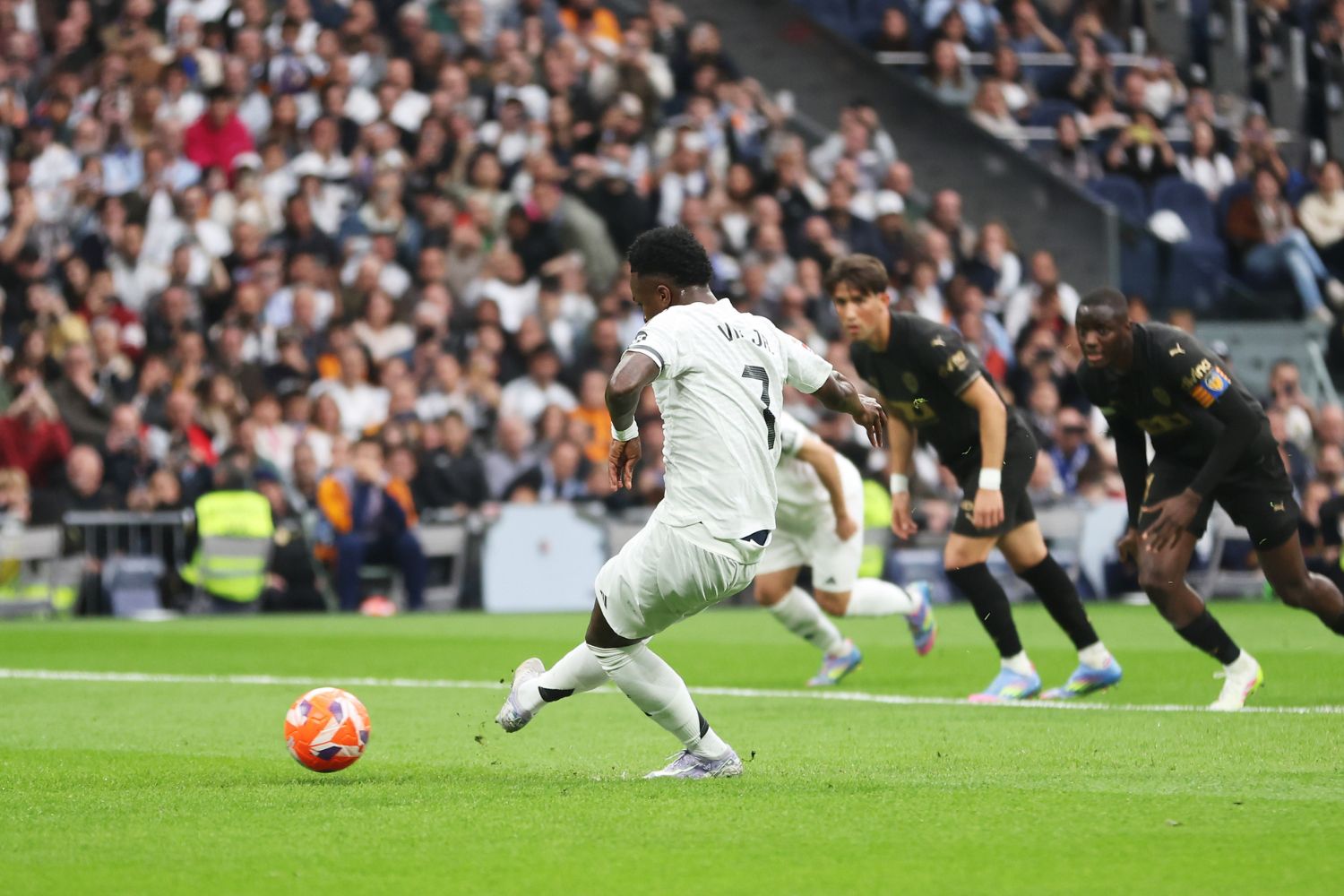 Vinicius Junior of Real Madrid takes a penalty that is saved by Giorgi Mamardashvili