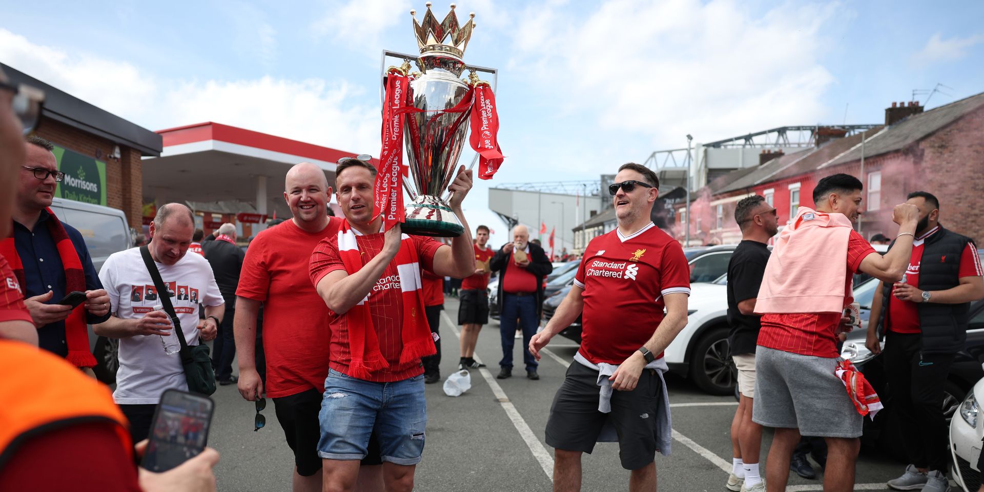 Liverpool fans celebrate with a replica Premier League trophy