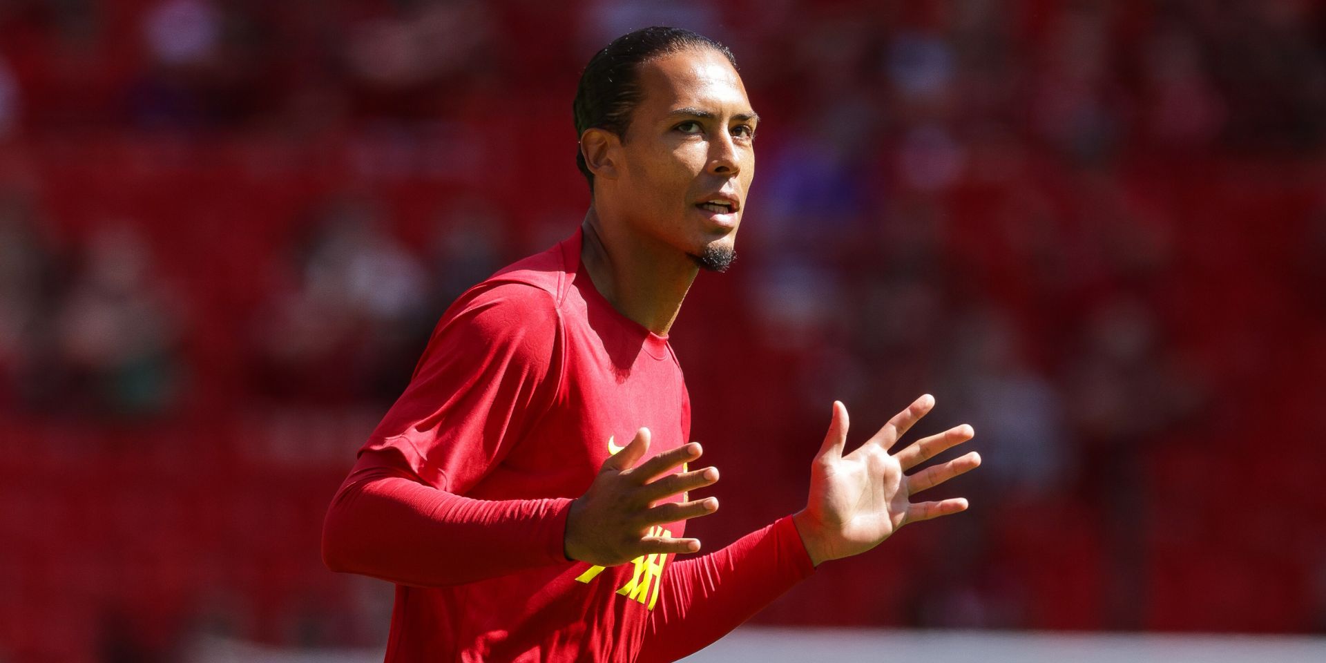 Virgil van Dijk warms up at Anfield