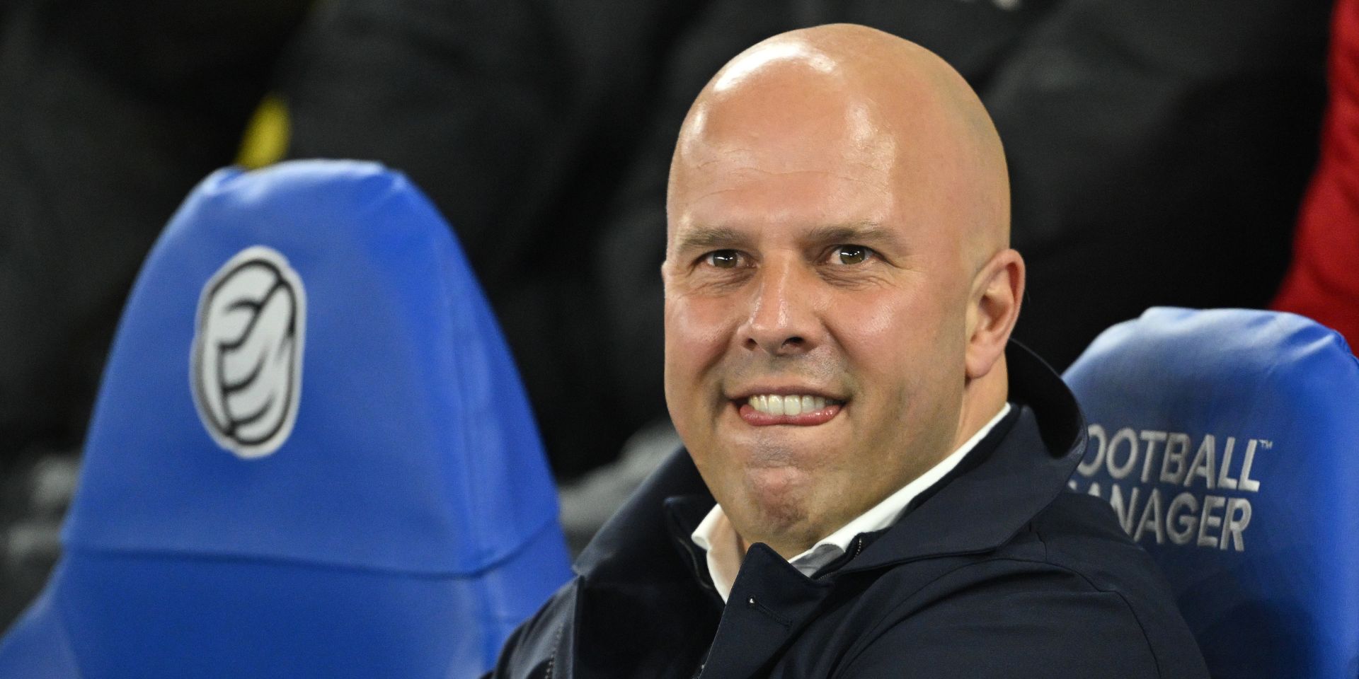 Arne Slot sits on the bench at the AMEX