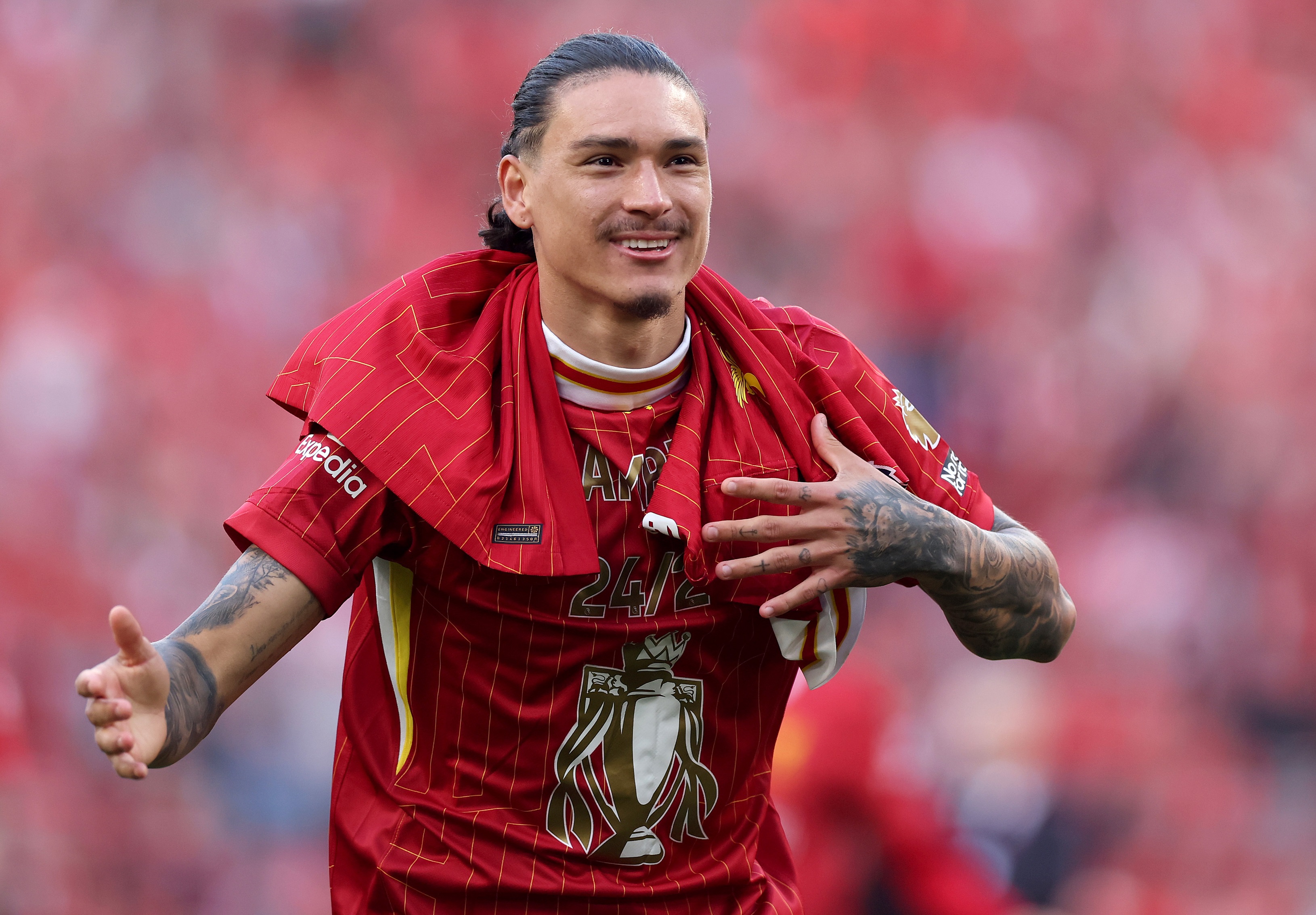 Darwin Nunez taps his chest during Premier League celebrations.