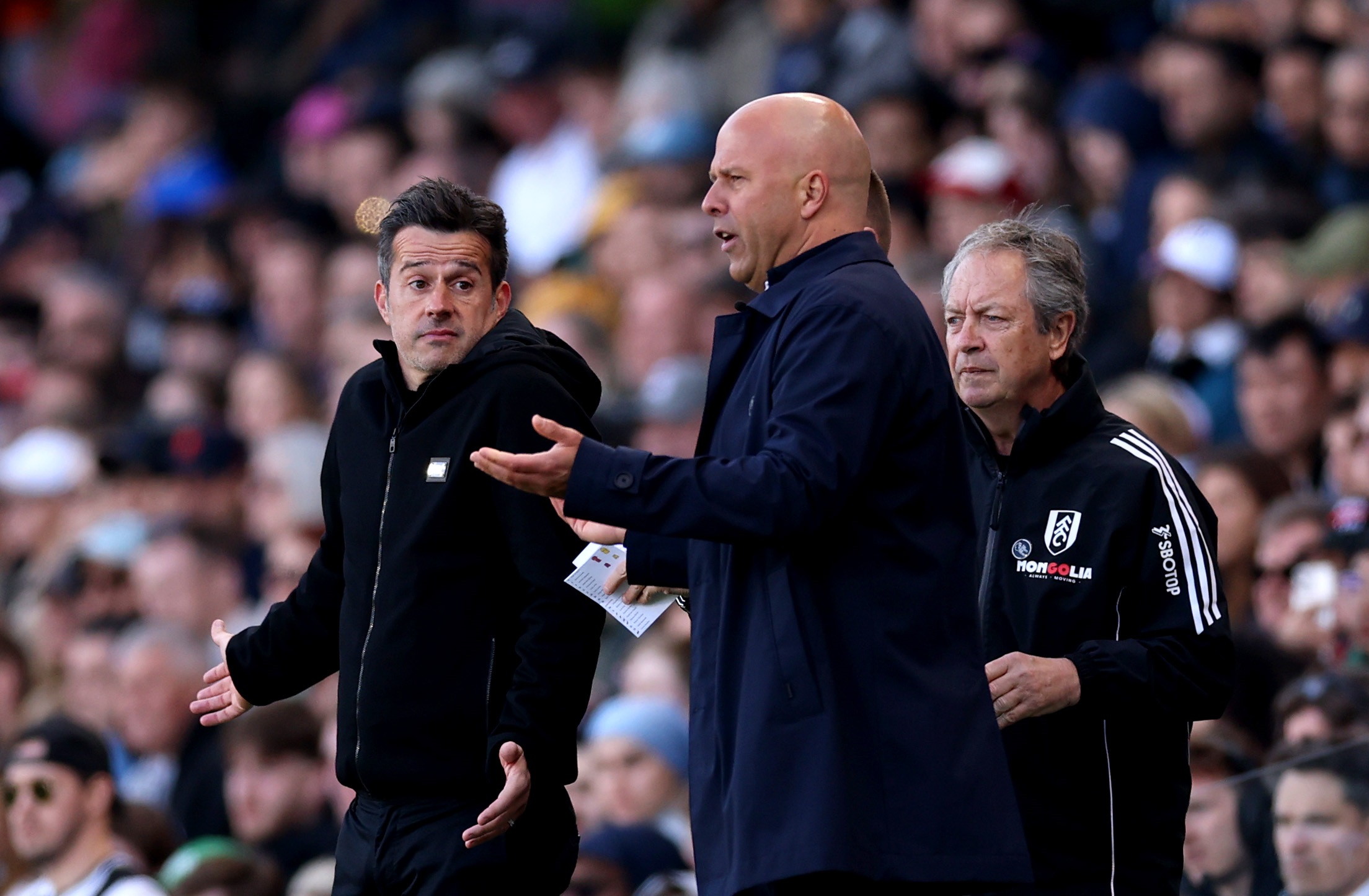 Marco Silva looks at Liverpool head coach Arne Slot.