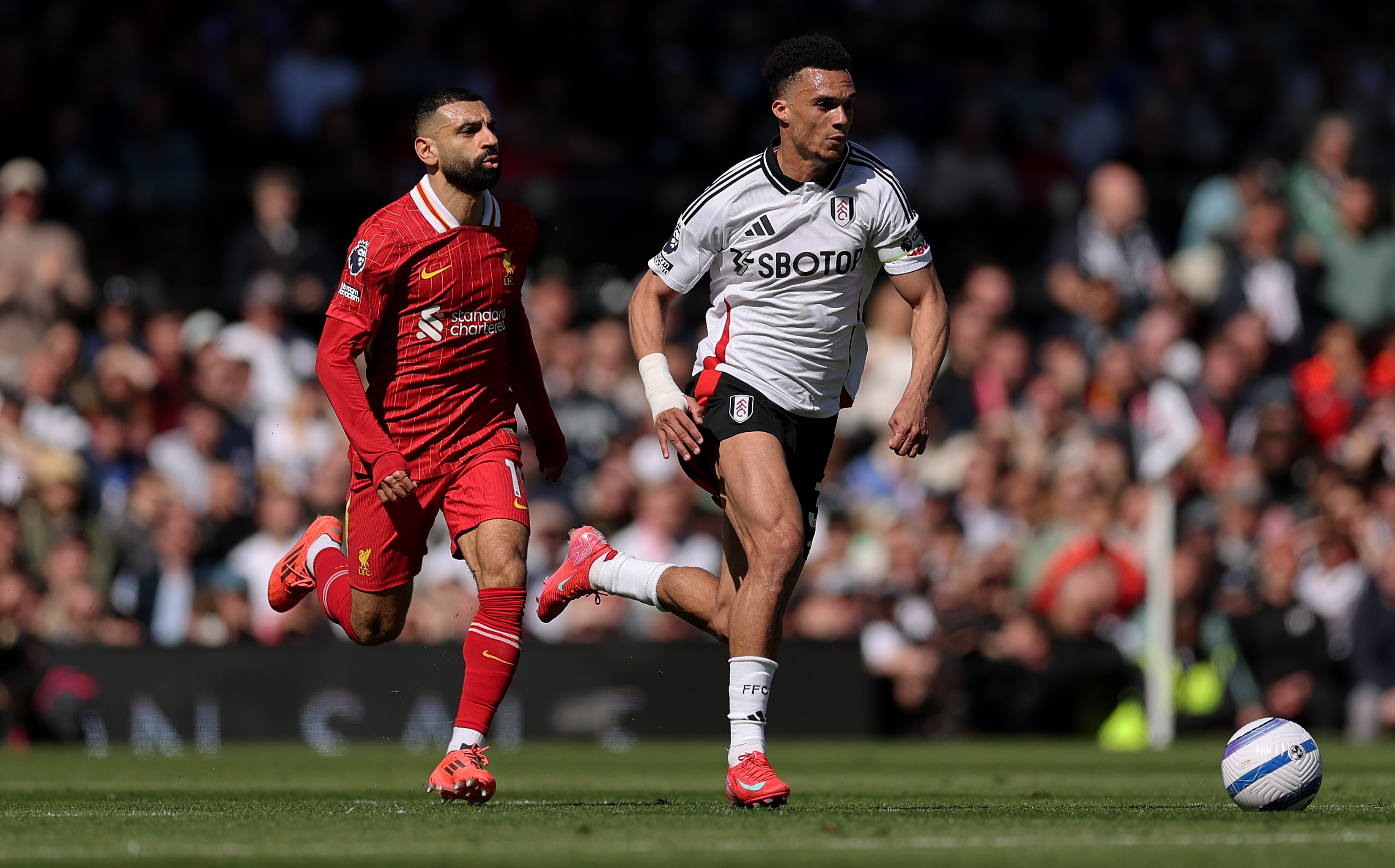 Mo Salah runs behind Antonee Robinson of Fulham.