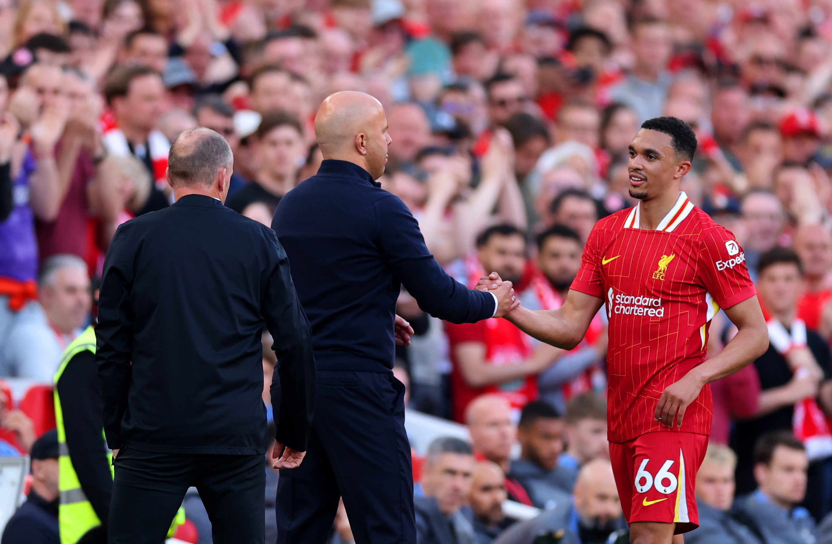 Trent Alexander-Arnold shakes hands with Arne Slot at Anfield.
