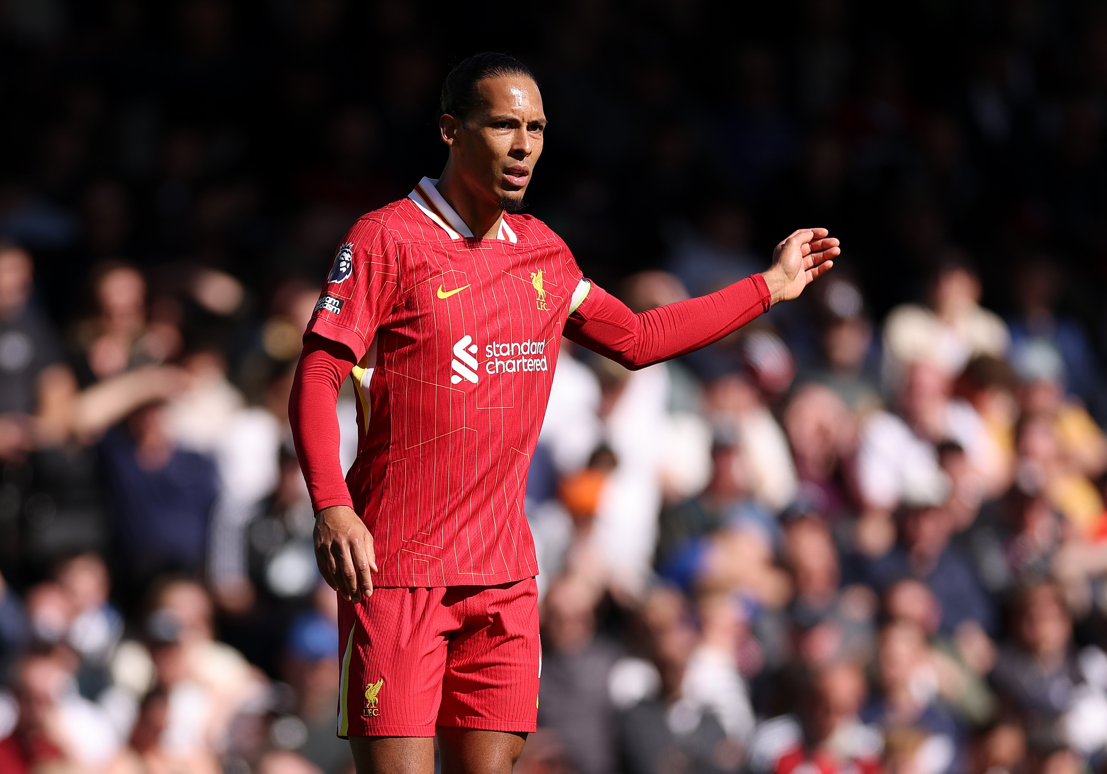 Virgil van Dijk holds out his arm during Liverpool game.