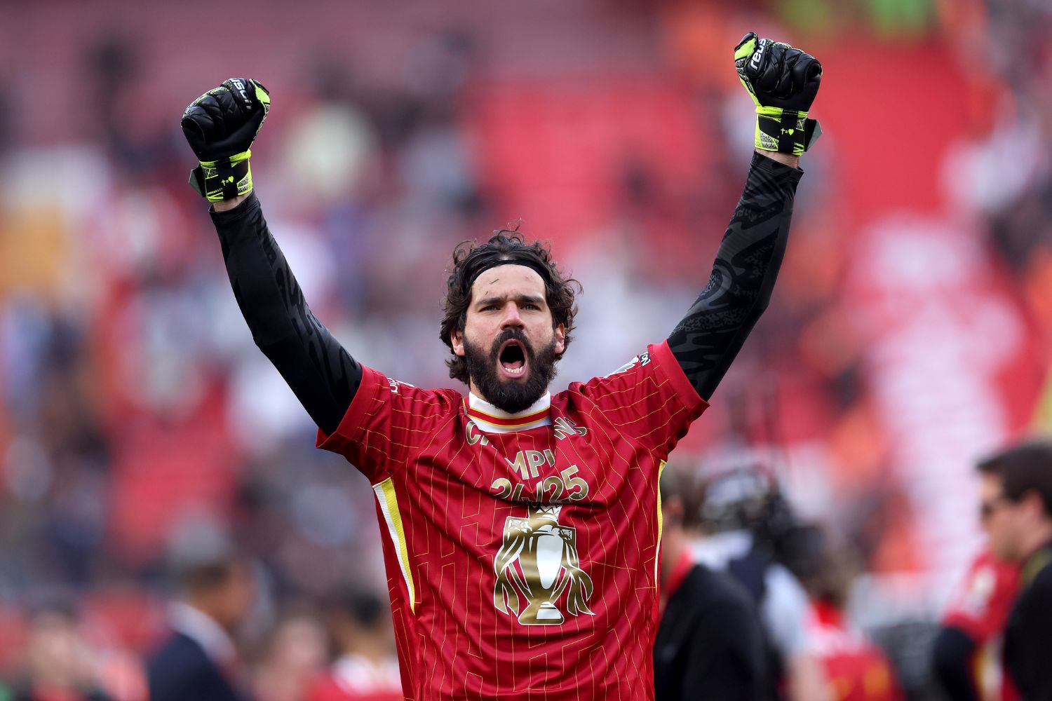 Alisson Becker celebrates winning the league