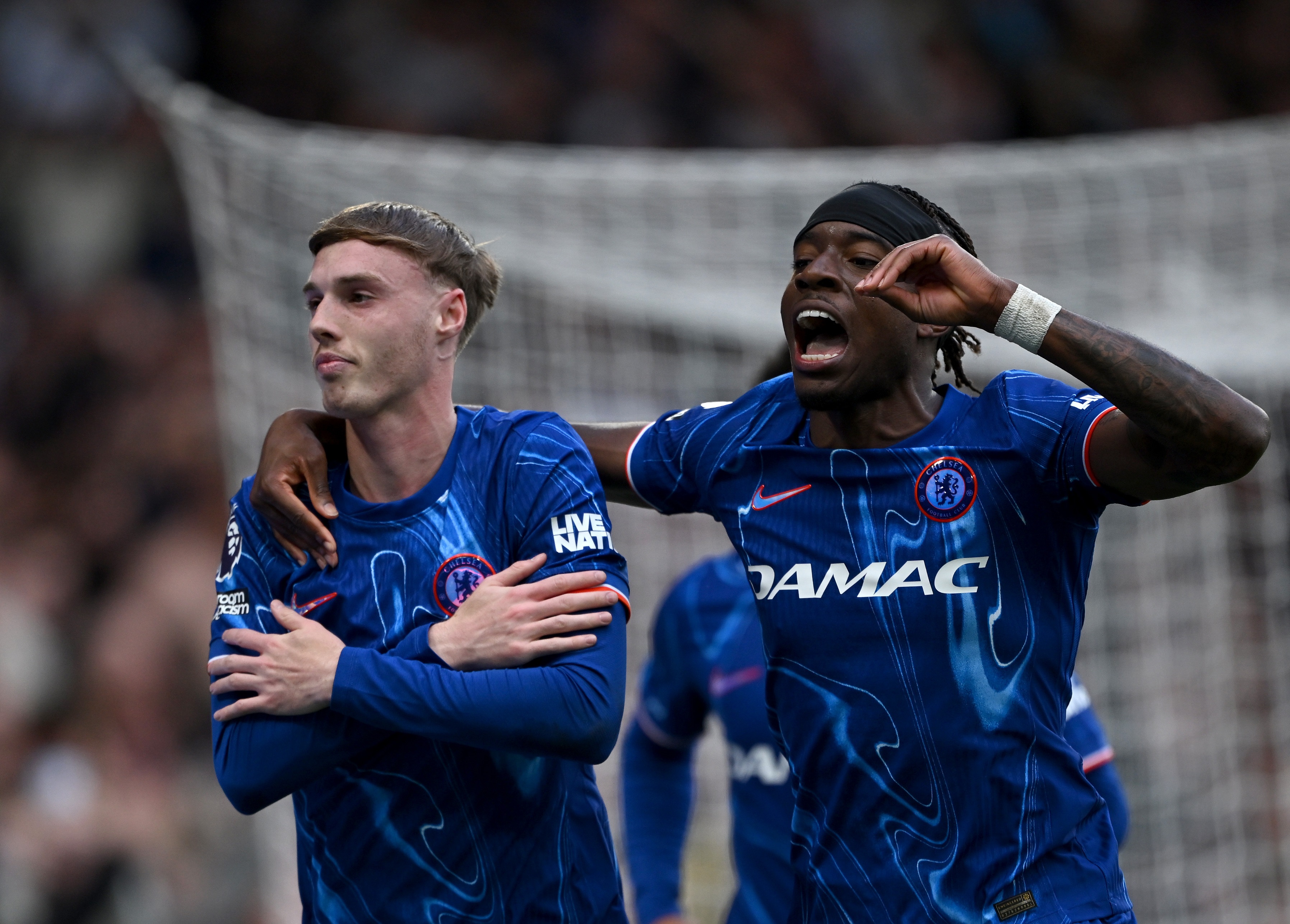 Cole Palmer rubs his arms to celebrate Chelsea goal against Liverpool.