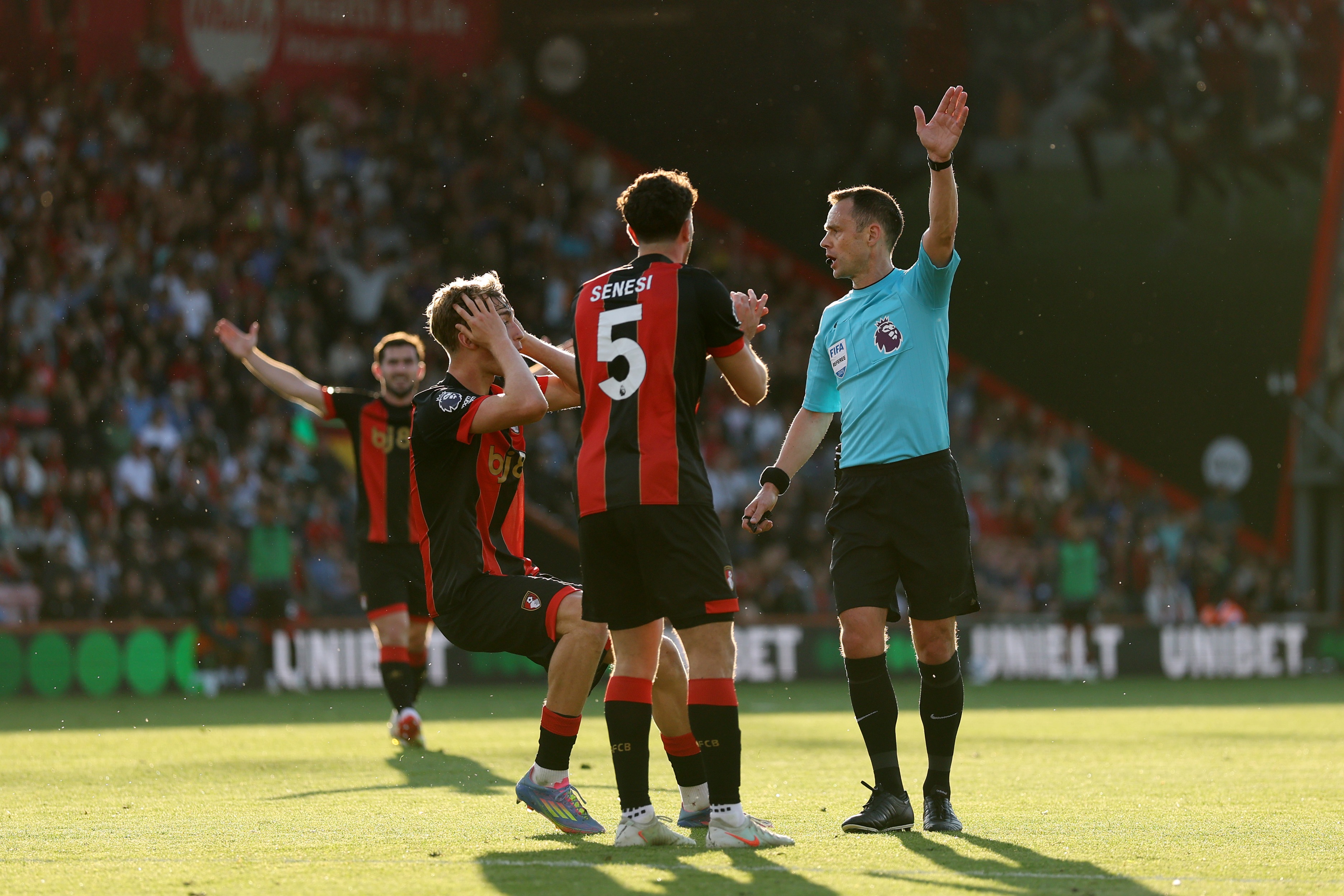 Dean Huijsen is in shock with hands on head after referee decision.