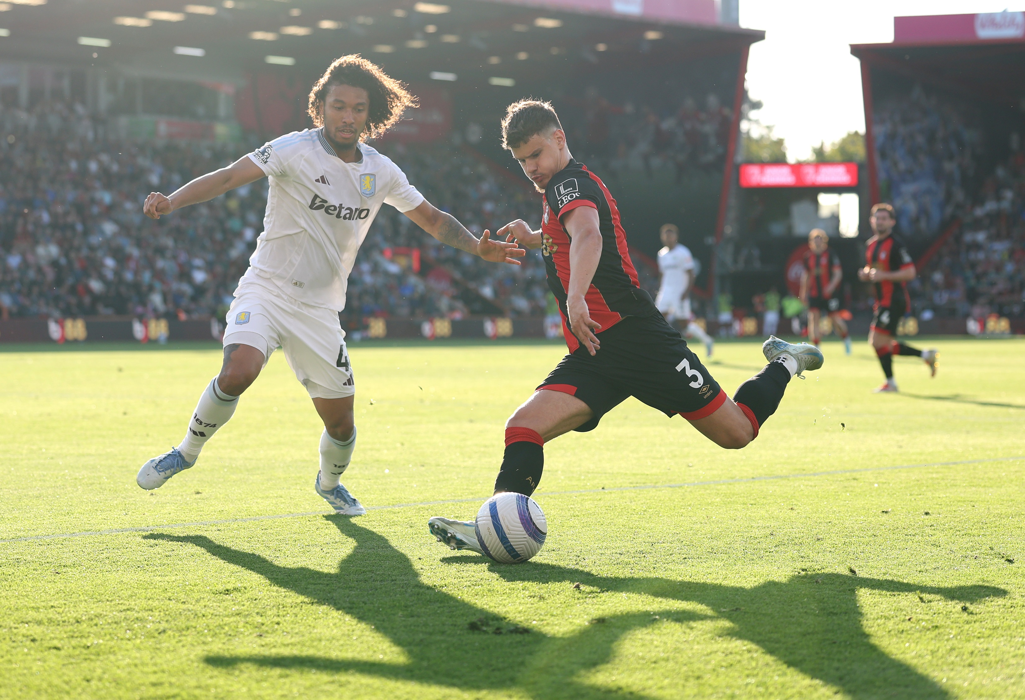 Milos Kerkez lifts back his leg to hit a cross whilst under pressure.