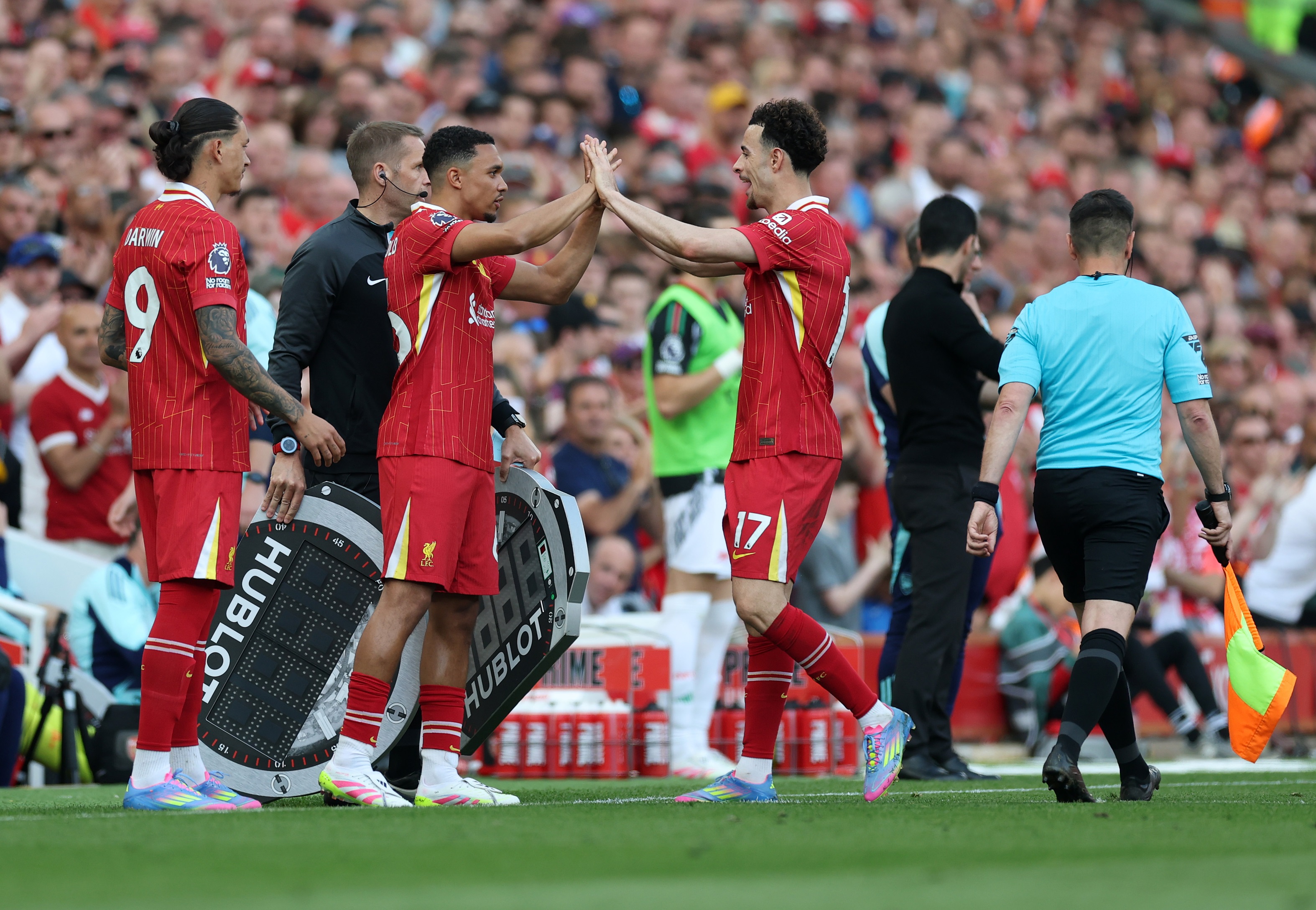Trent Alexander-Arnold high fives Curtis Jones on the touchline.
