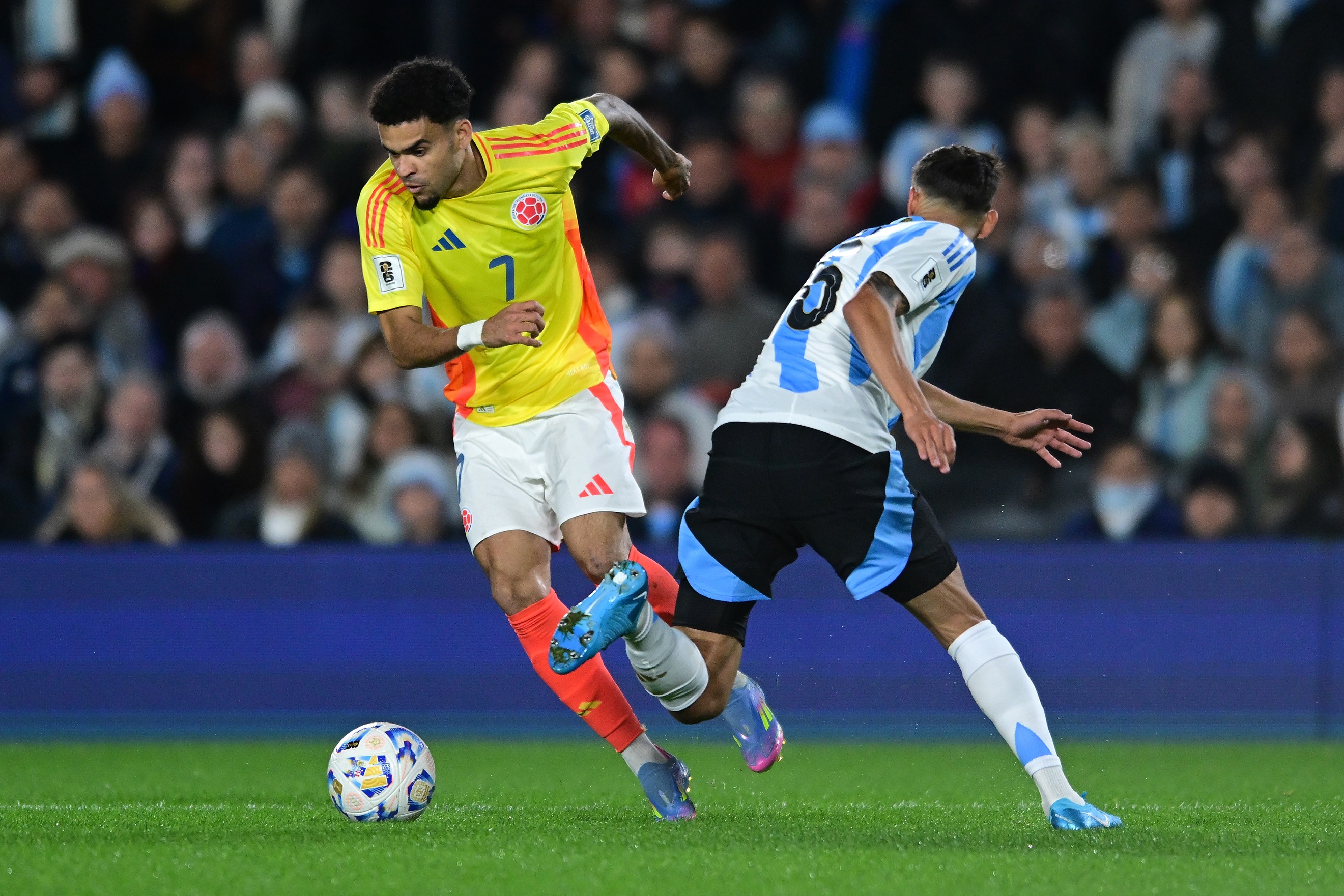 Luis Diaz dribbles past an Argentina player.