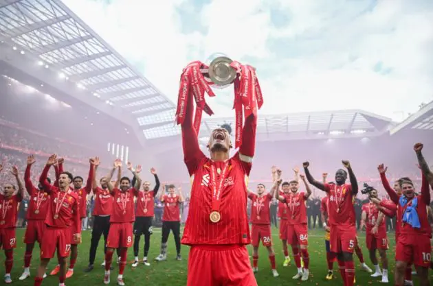 Virgil van Dijk raises the Premier League trophy at Anfield